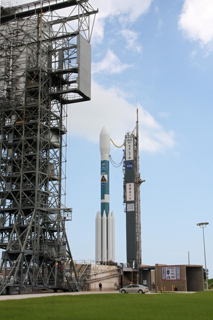 CAPE CANAVERAL, Fla. – A worker stands nearby as the United Launch Alliance Delta II heavy rocket at Space Launch Complex 17B, carrying NASA's Gravity Recovery and Interior Laboratory spacecraft, is rolled back around to the mobile service tower after the first launch attempt was scrubbed due to upper-level winds. GRAIL is scheduled for another launch attempt Sept.10 at 8:29:45 a.m. EDT at Cape Canaveral Air Force Station, Florida.    GRAIL will fly twin spacecraft in tandem around the moon to precisely measure and map variations in the moon's gravitational field. The mission will provide the most accurate global gravity field to date for any planet, including Earth. This detailed information will reveal differences in the density of the moon's crust and mantle and will help answer fundamental questions about the moon's internal structure, thermal evolution, and history of collisions with asteroids. The aim is to map the moon's gravity field so completely that future moon vehicles can safely navigate anywhere on the moon’s surface. For more information, visit http://www.nasa.gov/grail. Photo credit: NASA/Ken Thornsley