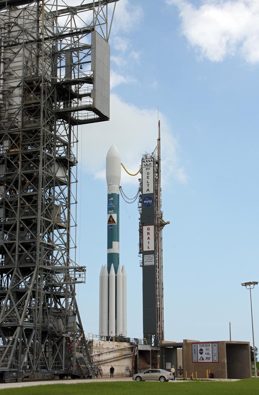 CAPE CANAVERAL, Fla. – A worker stands nearby as the United Launch Alliance Delta II heavy rocket at Space Launch Complex 17B, carrying NASA's Gravity Recovery and Interior Laboratory spacecraft, is rolled back around to the mobile service tower after the first launch attempt was scrubbed due to upper-level winds. GRAIL is scheduled for another launch attempt Sept.10 at 8:29:45 a.m. EDT at Cape Canaveral Air Force Station, Florida.    GRAIL will fly twin spacecraft in tandem around the moon to precisely measure and map variations in the moon's gravitational field. The mission will provide the most accurate global gravity field to date for any planet, including Earth. This detailed information will reveal differences in the density of the moon's crust and mantle and will help answer fundamental questions about the moon's internal structure, thermal evolution, and history of collisions with asteroids. The aim is to map the moon's gravity field so completely that future moon vehicles can safely navigate anywhere on the moon’s surface. For more information, visit http://www.nasa.gov/grail. Photo credit: NASA/Ken Thornsley