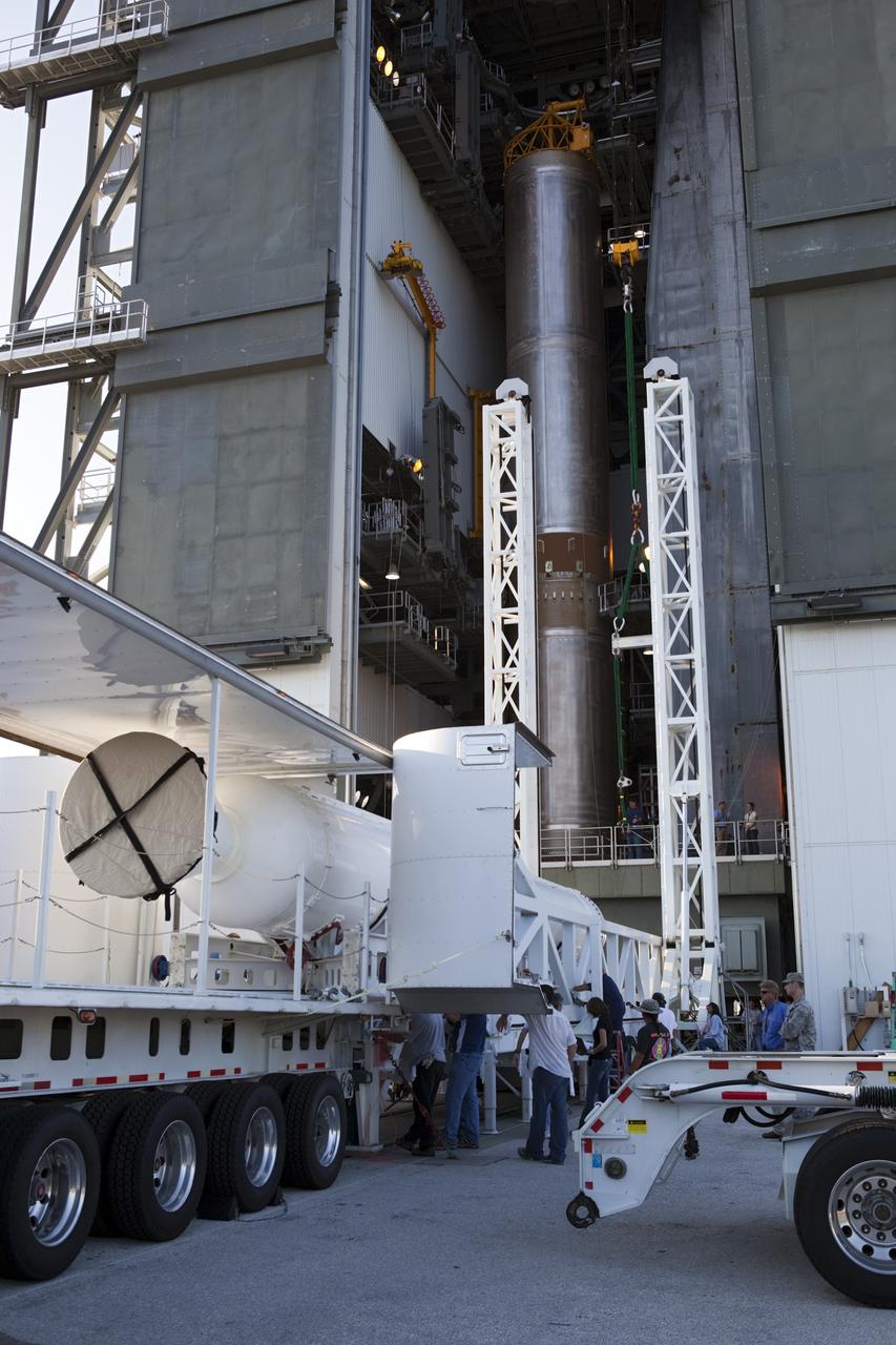 CAPE CANAVERAL, Fla. – At the Vertical Integration Facility at Space Launch Complex 41 on Cape Canaveral Air Force Station in Florida, technicians guide a solid rocket motor (SRM) off a trailer. The motor will be mated to a United Launch Alliance Atlas V rocket which will carry NASA's Mars Science Laboratory (MSL) mission. MSL's components include a compact car-sized rover, Curiosity, which has 10 science instruments designed to search for evidence on whether Mars has had environments favorable to microbial life, including chemical ingredients for life. The unique rover will use a laser to look inside rocks and release its gasses so that the rover’s spectrometer can analyze and send the data back to Earth. MSL is scheduled to launch Nov. 25 with a window extending to Dec. 18 and arrival at Mars Aug. 2012. For more information, visit http://www.nasa.gov/msl. Photo credit: NASA/Dimitri Gerondidakis