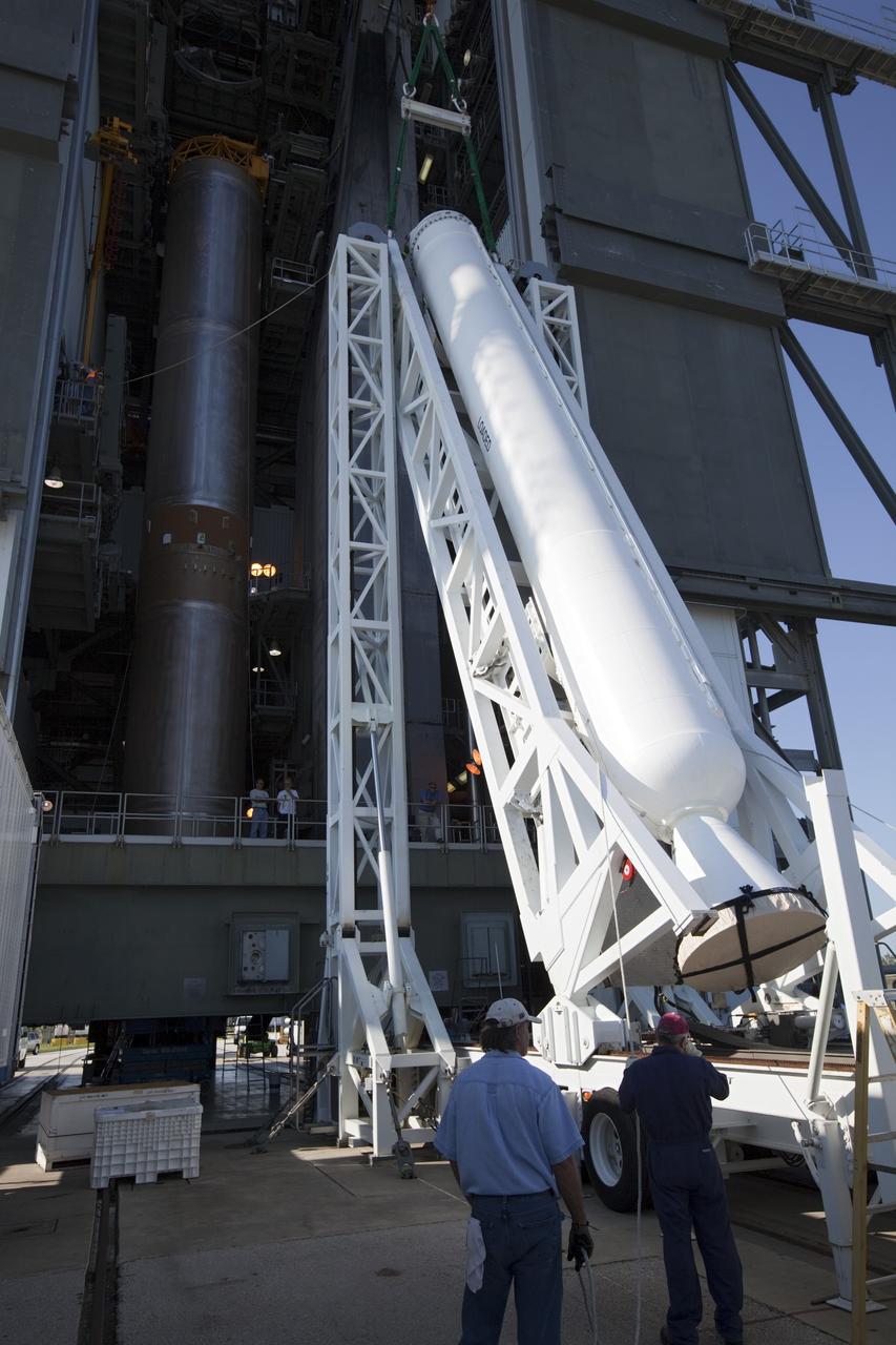 CAPE CANAVERAL, Fla. – At the Vertical Integration Facility at Space Launch Complex 41 on Cape Canaveral Air Force Station in Florida, technicians use a lifting device to elevate a solid rocket motor (SRM) into an upright position for mating to a United Launch Alliance Atlas V rocket which will carry NASA's Mars Science Laboratory (MSL) mission. MSL's components include a compact car-sized rover, Curiosity, which has 10 science instruments designed to search for evidence on whether Mars has had environments favorable to microbial life, including chemical ingredients for life. The unique rover will use a laser to look inside rocks and release its gasses so that the rover’s spectrometer can analyze and send the data back to Earth. MSL is scheduled to launch Nov. 25 with a window extending to Dec. 18 and arrival at Mars Aug. 2012. For more information, visit http://www.nasa.gov/msl. Photo credit: NASA/Dimitri Gerondidakis