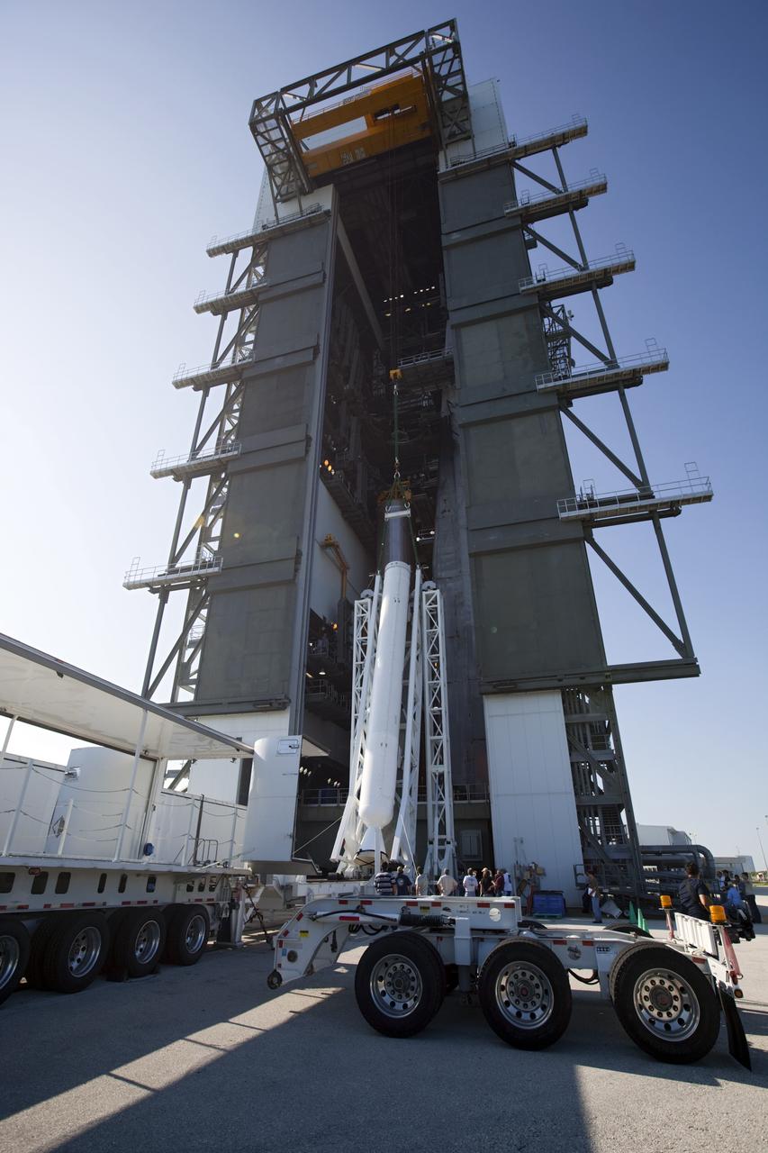CAPE CANAVERAL, Fla. – At the Vertical Integration Facility at Space Launch Complex 41 on Cape Canaveral Air Force Station in Florida, technicians use a lifting device to elevate a solid rocket motor (SRM) into an upright position for mating to a United Launch Alliance Atlas V rocket which will carry NASA's Mars Science Laboratory (MSL) mission. MSL's components include a compact car-sized rover, Curiosity, which has 10 science instruments designed to search for evidence on whether Mars has had environments favorable to microbial life, including chemical ingredients for life. The unique rover will use a laser to look inside rocks and release its gasses so that the rover’s spectrometer can analyze and send the data back to Earth. MSL is scheduled to launch Nov. 25 with a window extending to Dec. 18 and arrival at Mars Aug. 2012. For more information, visit http://www.nasa.gov/msl. Photo credit: NASA/Dimitri Gerondidakis