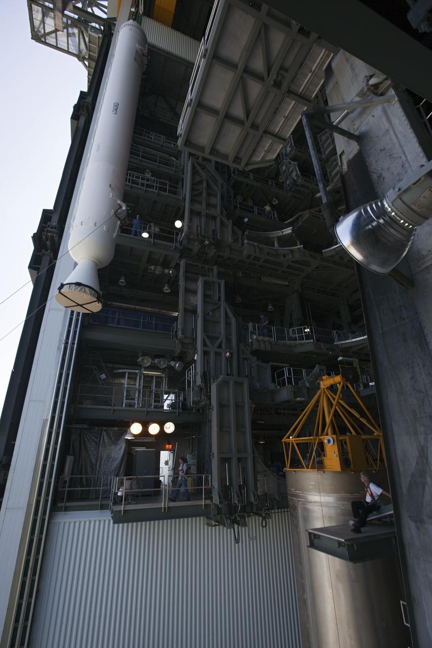 CAPE CANAVERAL, Fla. – Inside the Vertical Integration Facility at Space Launch Complex 41 on Cape Canaveral Air Force Station in Florida, a crane positions a solid rocket motor (SRM) for mating to the first stage of a United Launch Alliance Atlas V rocket. The Atlas V will carry NASA's Mars Science Laboratory (MSL) mission into space. MSL's components include a compact car-sized rover, Curiosity, which has 10 science instruments designed to search for evidence on whether Mars has had environments favorable to microbial life, including chemical ingredients for life. The unique rover will use a laser to look inside rocks and release its gasses so that the rover’s spectrometer can analyze and send the data back to Earth. MSL is scheduled to launch Nov. 25 with a window extending to Dec. 18 and arrival at Mars Aug. 2012. For more information, visit http://www.nasa.gov/msl. Photo credit: NASA/Dimitri Gerondidakis