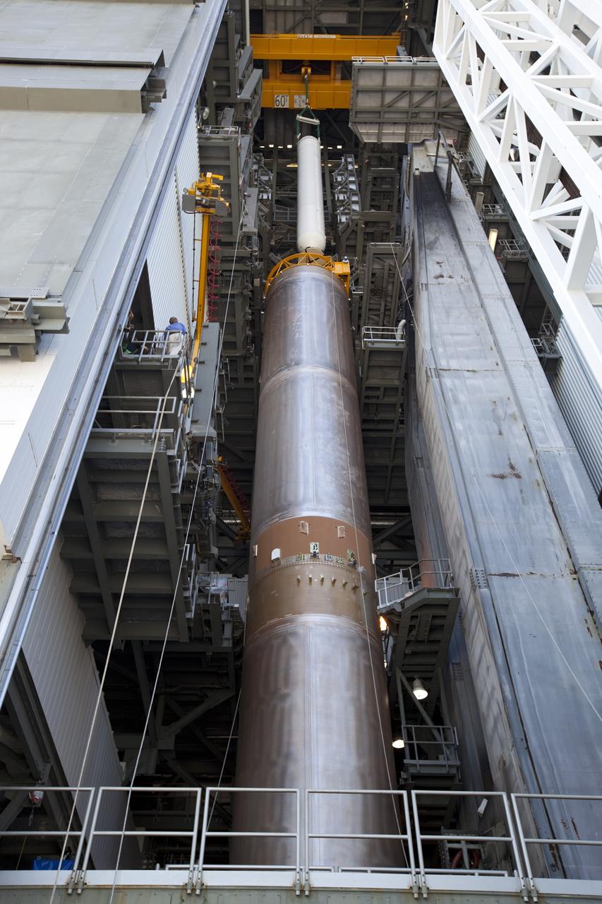 CAPE CANAVERAL, Fla. – At the Vertical Integration Facility at Space Launch Complex 41 on Cape Canaveral Air Force Station in Florida, a technician monitors the progress as a crane lifts a solid rocket motor (SRM) for mating to the first stage of a United Launch Alliance Atlas V rocket. The Atlas V will carry NASA's Mars Science Laboratory (MSL) mission into space. MSL's components include a compact car-sized rover, Curiosity, which has 10 science instruments designed to search for evidence on whether Mars has had environments favorable to microbial life, including chemical ingredients for life. The unique rover will use a laser to look inside rocks and release its gasses so that the rover’s spectrometer can analyze and send the data back to Earth. MSL is scheduled to launch Nov. 25 with a window extending to Dec. 18 and arrival at Mars Aug. 2012. For more information, visit http://www.nasa.gov/msl. Photo credit: NASA/Dimitri Gerondidakis