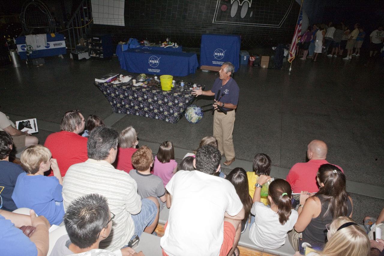 CAPE CANAVERAL, Fla. – An education specialist talks to children and their parents during Kennedy Space Center’s Family Night, Sept. 10, at the U.S. Astronaut Hall of Fame in Florida.    NASA and the Kennedy Space Center Visitor Complex hosted the annual NASA family education night. The event, for fifth- through eighth-grade students and their parents, focuses on science, technology, engineering and mathematics (STEM) education activities that included astronaut appearances, a hovercraft, vortex cannon and alternative fuel vehicles. The back-to-school event is part of NASA’s Summer of Innovation initiative to provide interactive learning experiences to middle school students nationwide.  Photo credit: NASA/Amanda Diller