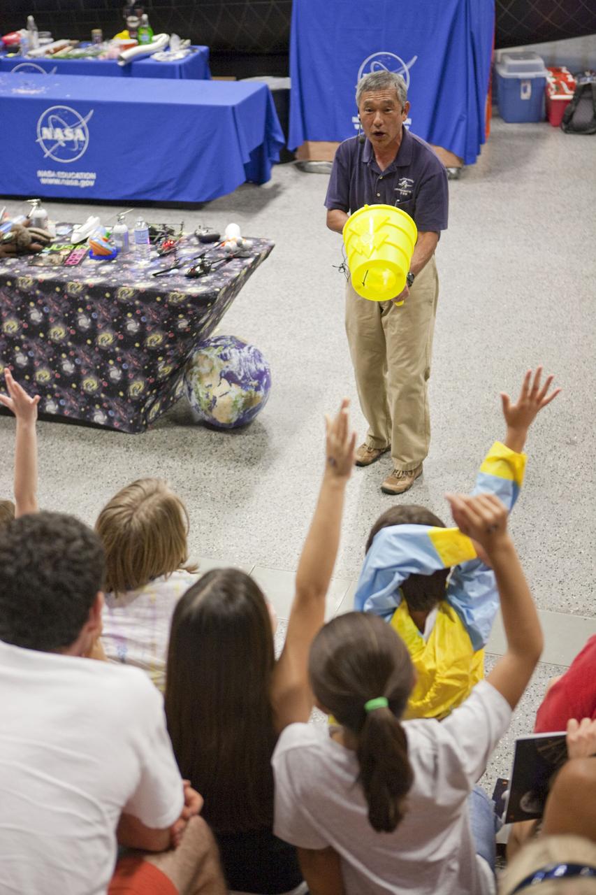 CAPE CANAVERAL, Fla. – An education specialist engages children in an educational activity during Kennedy Space Center’s Family Night, Sept. 10, at the U.S. Astronaut Hall of Fame in Florida.    NASA and the Kennedy Space Center Visitor Complex hosted the annual NASA family education night. The event, for fifth- through eighth-grade students and their parents, focuses on science, technology, engineering and mathematics (STEM) education activities that included astronaut appearances, a hovercraft, vortex cannon and alternative fuel vehicles. The back-to-school event is part of NASA’s Summer of Innovation initiative to provide interactive learning experiences to middle school students nationwide.  Photo credit: NASA/Amanda Diller