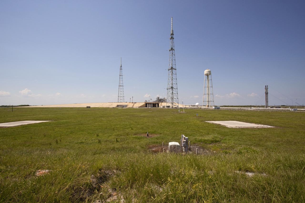 CAPE CANAVERAL, Fla. – The deconstruction of Launch Pad 39B at NASA’s Kennedy Space Center in Florida is complete. Still remaining and standing over the remnants of the fixed service structure are the 600-foot-tall lightning protection towers and the water tower used for sound suppression. In 2009, the structure at the pad was no longer needed for NASA's Space Shuttle Program, so it is being restructured for future use. The new design will feature a "clean pad" for rockets to come with their own launcher, making it more versatile for a number of vehicles. For information on NASA's future plans, visit http://www.nasa.gov/exploration. Photo credit: NASA/Jim Grossmann