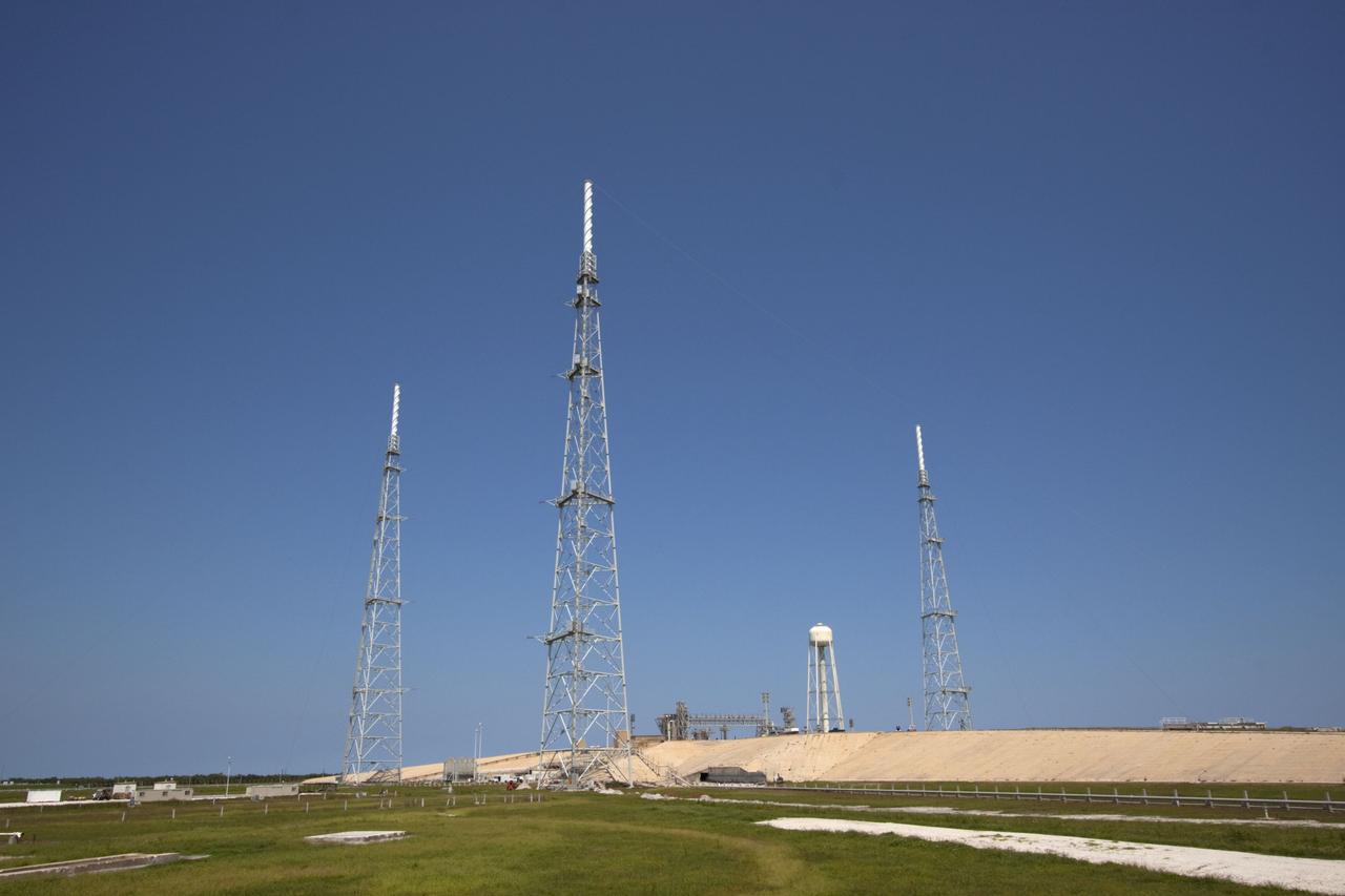 CAPE CANAVERAL, Fla. – The deconstruction of Launch Pad 39B at NASA’s Kennedy Space Center in Florida is complete. Still remaining and standing over the remnants of the fixed service structure are the three 600-foot-tall lightning protection towers and the water tower used for sound suppression. In 2009, the structure at the pad was no longer needed for NASA's Space Shuttle Program, so it is being restructured for future use. The new design will feature a "clean pad" for rockets to come with their own launcher, making it more versatile for a number of vehicles. For information on NASA's future plans, visit http://www.nasa.gov/exploration. Photo credit: NASA/Jim Grossmann