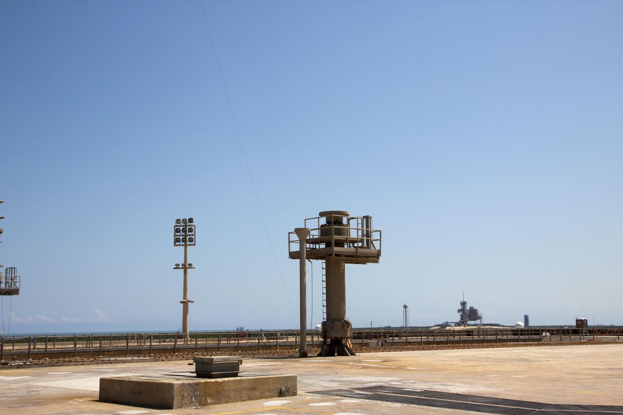 CAPE CANAVERAL, Fla. – The deconstruction of Launch Pad 39B at NASA’s Kennedy Space Center in Florida is complete. A pedestal remains standing at the pad where a distant view of Launch Pad 39A can be seen. In 2009, the structure at the pad was no longer needed for NASA's Space Shuttle Program, so it is being restructured for future use. The new design will feature a "clean pad" for rockets to come with their own launcher, making it more versatile for a number of vehicles. For information on NASA's future plans, visit http://www.nasa.gov/exploration. Photo credit: NASA/Jim Grossmann
