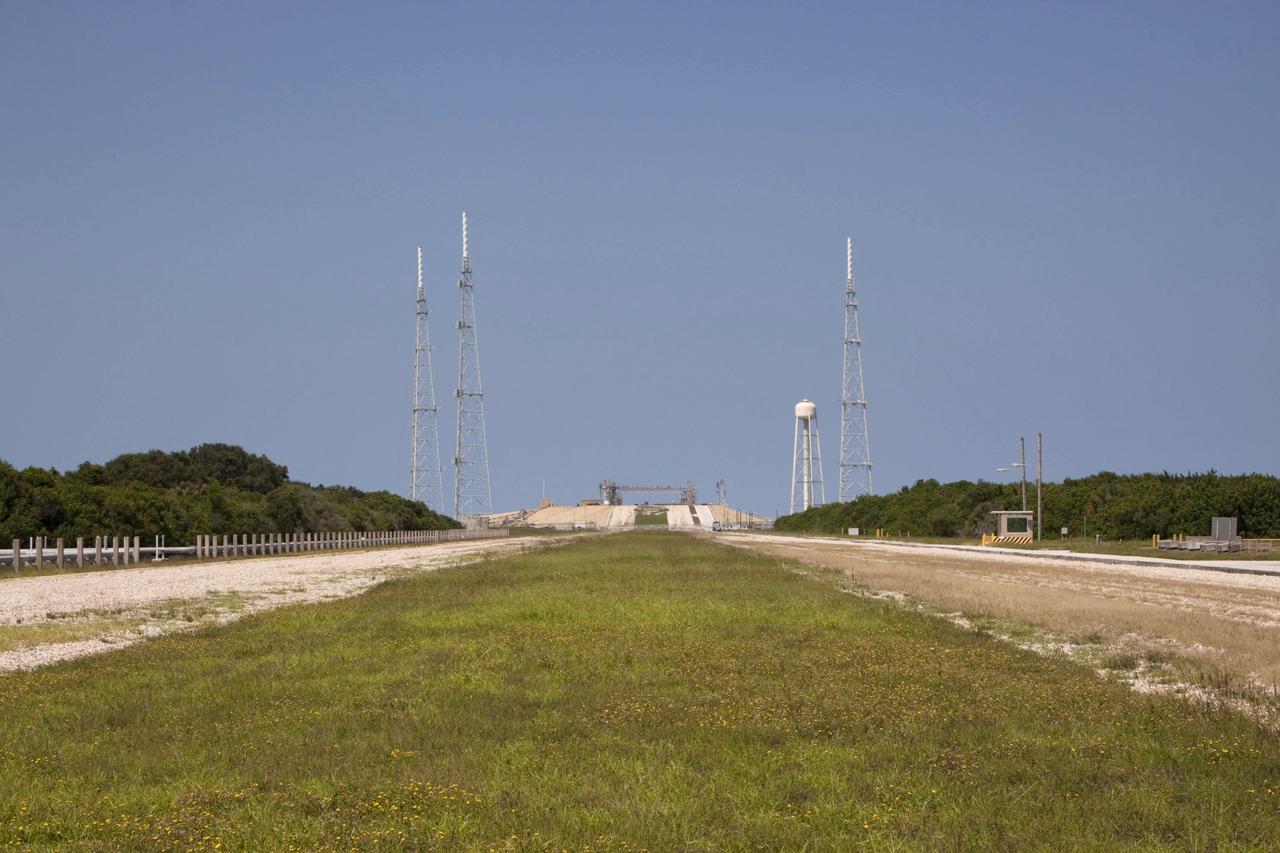 CAPE CANAVERAL, Fla. – The deconstruction of Launch Pad 39B at NASA’s Kennedy Space Center in Florida is complete. With a view from the two-track crawlerway, the three 600-foot-tall lightning protection towers and the water tower used for sound suppression stand over the remnants of the fixed service structure. In 2009, the structure at the pad was no longer needed for NASA's Space Shuttle Program, so it is being restructured for future use. The new design will feature a "clean pad" for rockets to come with their own launcher, making it more versatile for a number of vehicles. For information on NASA's future plans, visit http://www.nasa.gov/exploration. Photo credit: NASA/Jim Grossmann