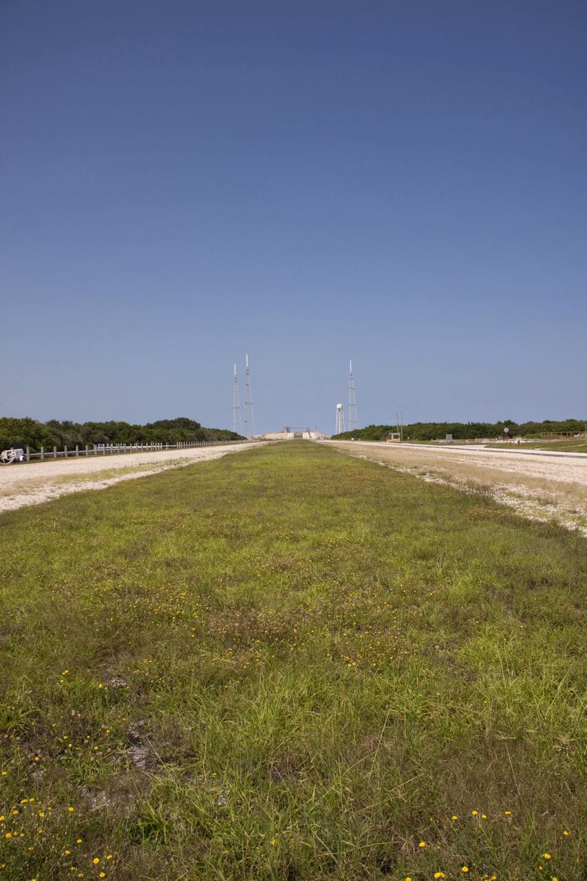 CAPE CANAVERAL, Fla. – The deconstruction of Launch Pad 39B at NASA’s Kennedy Space Center in Florida is complete. With a view from the two-track crawlerway, the three 600-foot-tall lightning protection towers and the water tower used for sound suppression stand over the remnants of the fixed service structure. In 2009, the structure at the pad was no longer needed for NASA's Space Shuttle Program, so it is being restructured for future use. The new design will feature a "clean pad" for rockets to come with their own launcher, making it more versatile for a number of vehicles. For information on NASA's future plans, visit http://www.nasa.gov/exploration. Photo credit: NASA/Jim Grossmann