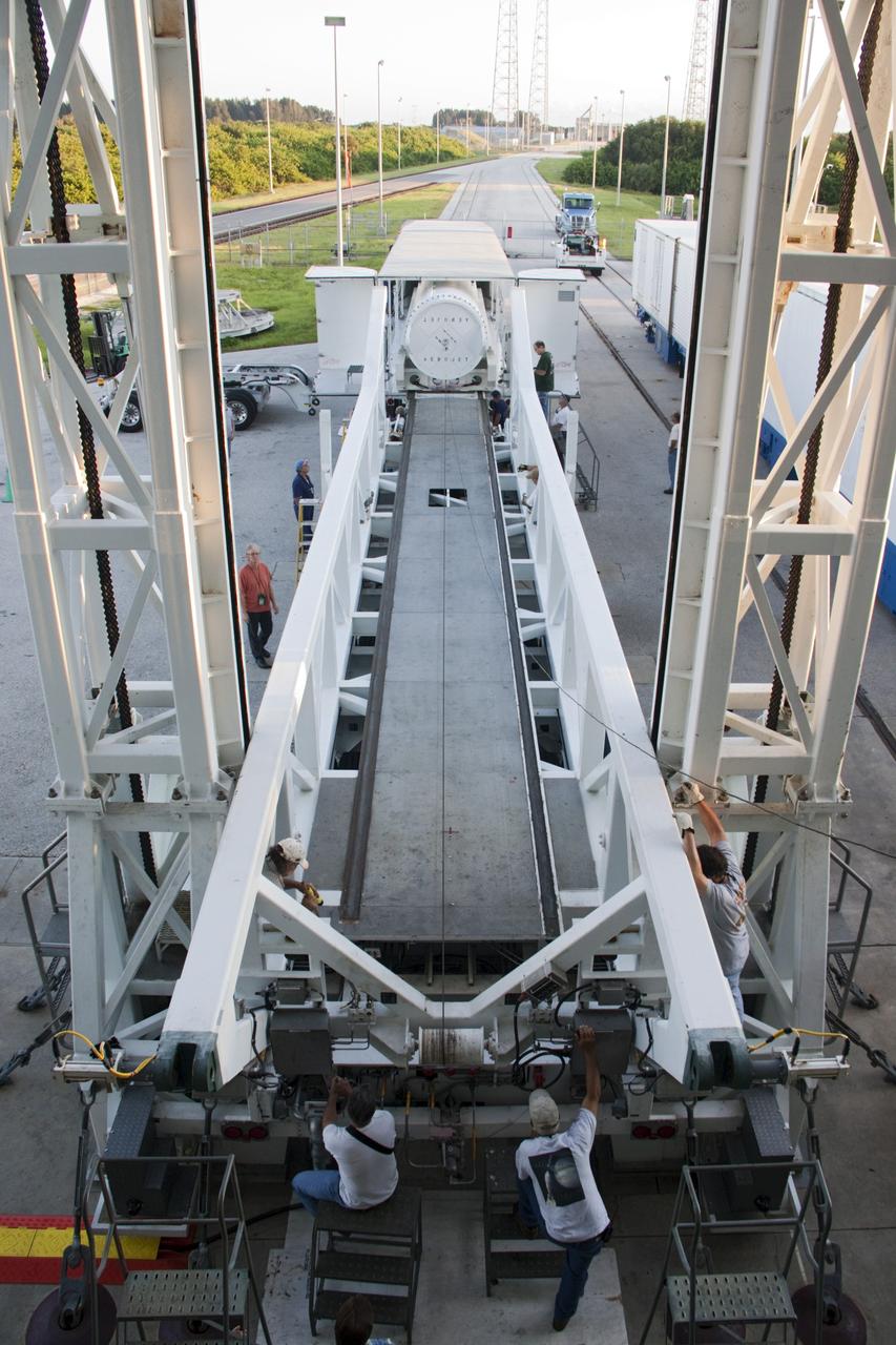 CAPE CANAVERAL, Fla. – With a view from an upper level at the Vertical Integration Facility at Space Launch Complex 41 on Cape Canaveral Air Force Station in Florida, technicians monitor as the final solid rocket motor (SRM) is being prepared for mating to a United Launch Alliance Atlas V rocket. The Atlas V will carry NASA's Mars Science Laboratory (MSL) mission into space.    MSL's components include a compact car-sized rover, Curiosity, which has 10 science instruments designed to search for evidence on whether Mars has had environments favorable to microbial life, including chemical ingredients for life.  The unique rover will use a laser to look inside rocks and release its gasses so that the rover’s spectrometer can analyze and send the data back to Earth. MSL is scheduled to launch Nov. 25 with a window extending to Dec. 18 and arrival at Mars Aug. 2012. For more information, visit http://www.nasa.gov/msl. Photo credit: NASA/Jim Grossmann