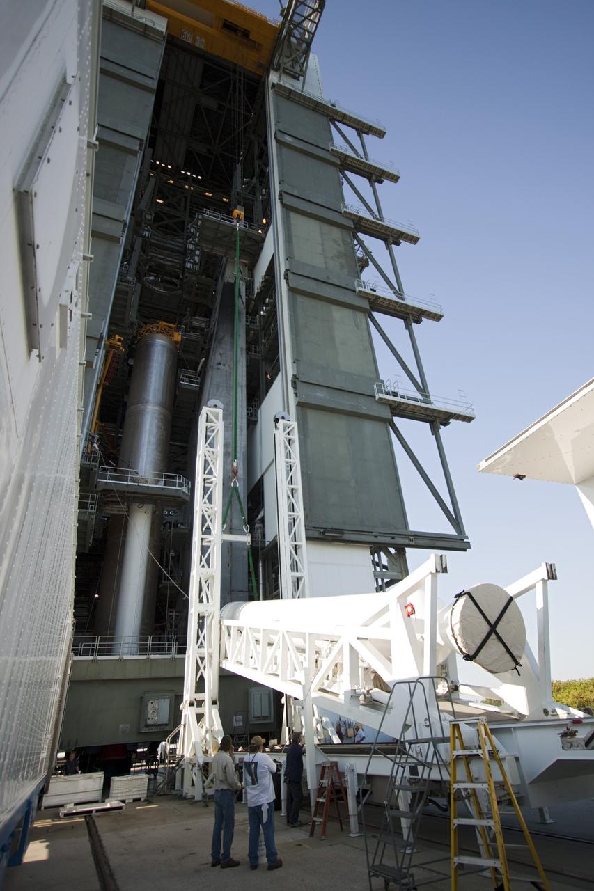 CAPE CANAVERAL, Fla. – At the Vertical Integration Facility at Space Launch Complex 41 on Cape Canaveral Air Force Station in Florida, technicians use a lifting device to elevate the final solid rocket motor (SRM) into an upright position for mating to a United Launch Alliance Atlas V rocket. The Atlas V will carry NASA's Mars Science Laboratory (MSL) mission into space. MSL's components include a compact car-sized rover, Curiosity, which has 10 science instruments designed to search for evidence on whether Mars has had environments favorable to microbial life, including chemical ingredients for life. The unique rover will use a laser to look inside rocks and release its gasses so that the rover’s spectrometer can analyze and send the data back to Earth. MSL is scheduled to launch Nov. 25 with a window extending to Dec. 18 and arrival at Mars Aug. 2012. For more information, visit http://www.nasa.gov/msl. Photo credit: NASA/Jim Grossmann