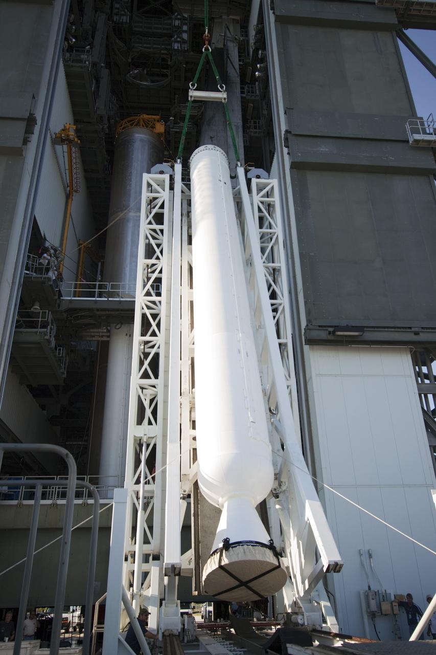 CAPE CANAVERAL, Fla. – At the Vertical Integration Facility at Space Launch Complex 41 on Cape Canaveral Air Force Station in Florida, the final solid rocket motor (SRM) hangs in an upright position for mating to a United Launch Alliance Atlas V rocket which will carry NASA's Mars Science Laboratory (MSL) mission. MSL's components include a compact car-sized rover, Curiosity, which has 10 science instruments designed to search for evidence on whether Mars has had environments favorable to microbial life, including chemical ingredients for life. The unique rover will use a laser to look inside rocks and release its gasses so that the rover’s spectrometer can analyze and send the data back to Earth. MSL is scheduled to launch Nov. 25 with a window extending to Dec. 18 and arrival at Mars Aug. 2012. For more information, visit http://www.nasa.gov/msl. Photo credit: NASA/Jim Grossmann