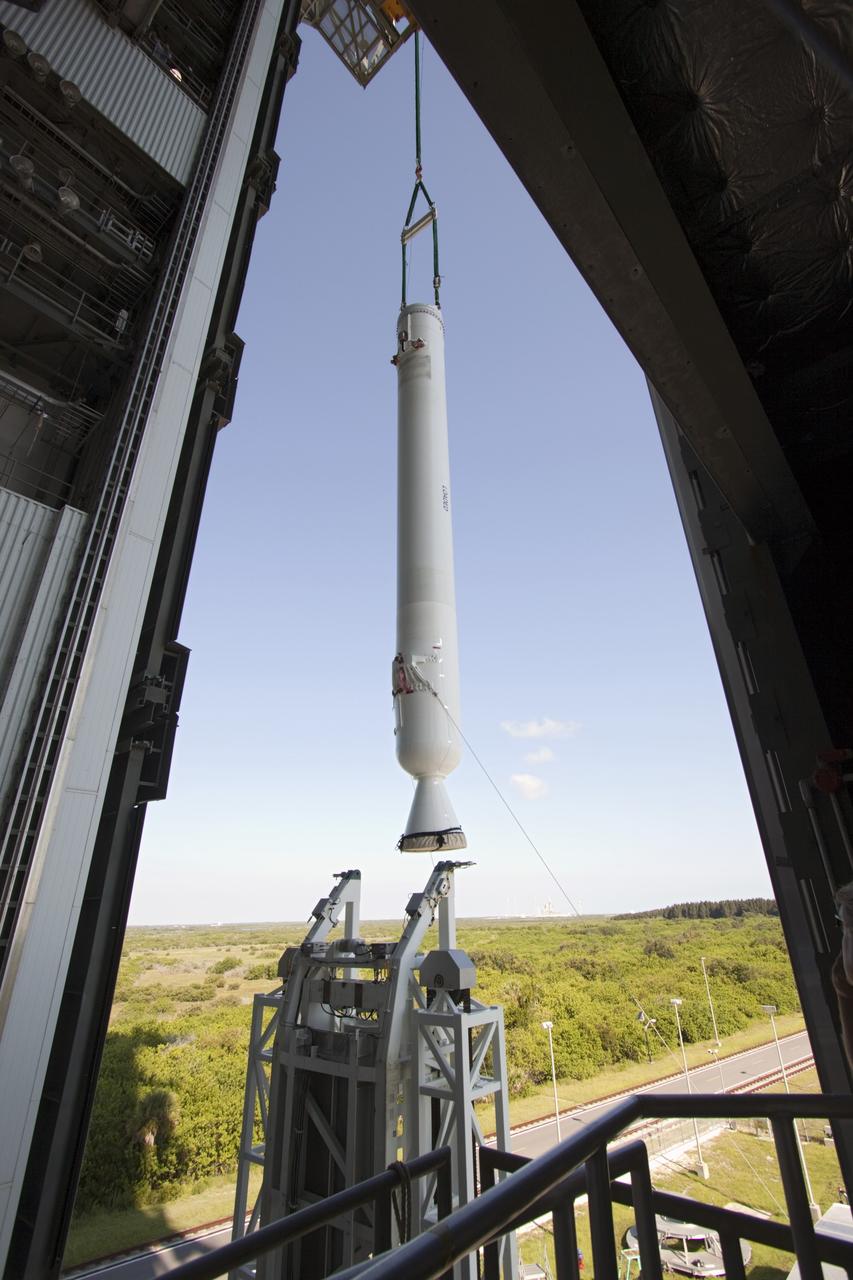 CAPE CANAVERAL, Fla. – With a view taken from inside the Vertical Integration Facility at Space Launch Complex 41 on Cape Canaveral Air Force Station in Florida, the final solid rocket motor (SRM) hangs in an upright position for mating to a United Launch Alliance Atlas V rocket which will carry NASA's Mars Science Laboratory (MSL) mission. MSL's components include a compact car-sized rover, Curiosity, which has 10 science instruments designed to search for evidence on whether Mars has had environments favorable to microbial life, including chemical ingredients for life. The unique rover will use a laser to look inside rocks and release its gasses so that the rover’s spectrometer can analyze and send the data back to Earth. MSL is scheduled to launch Nov. 25 with a window extending to Dec. 18 and arrival at Mars Aug. 2012. For more information, visit http://www.nasa.gov/msl. Photo credit: NASA/Jim Grossmann