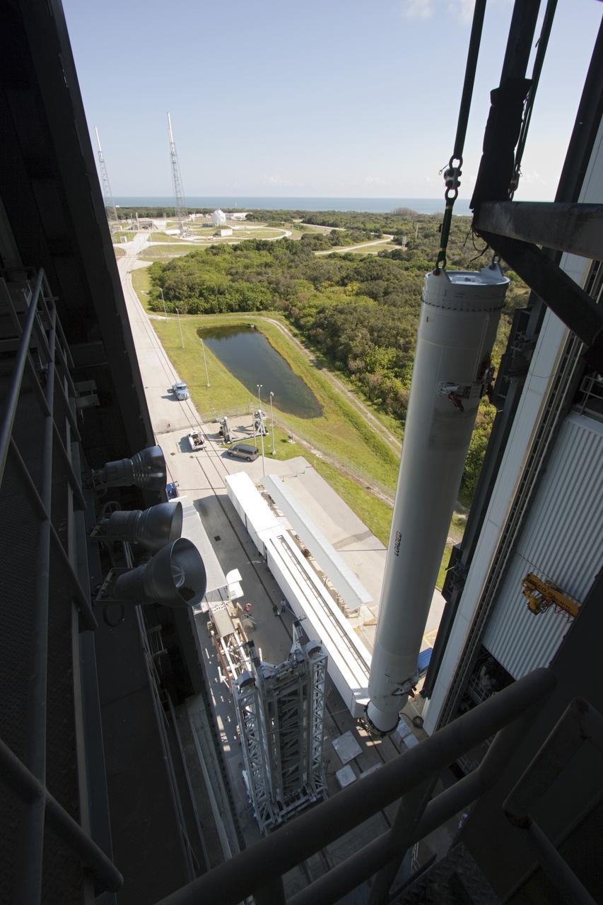 CAPE CANAVERAL, Fla. – A unique view is offered at the Vertical Integration Facility at Space Launch Complex 41 on Cape Canaveral Air Force Station in Florida, as the final solid rocket motor (SRM) hangs in an upright position for mating to a United Launch Alliance Atlas V rocket which will carry NASA's Mars Science Laboratory (MSL) mission.     MSL's components include a compact car-sized rover, Curiosity, which has 10 science instruments designed to search for evidence on whether Mars has had environments favorable to microbial life, including chemical ingredients for life.  The unique rover will use a laser to look inside rocks and release its gasses so that the rover’s spectrometer can analyze and send the data back to Earth. MSL is scheduled to launch Nov. 25 with a window extending to Dec. 18 and arrival at Mars Aug. 2012. For more information, visit http://www.nasa.gov/msl. Photo credit: NASA/Jim Grossmann
