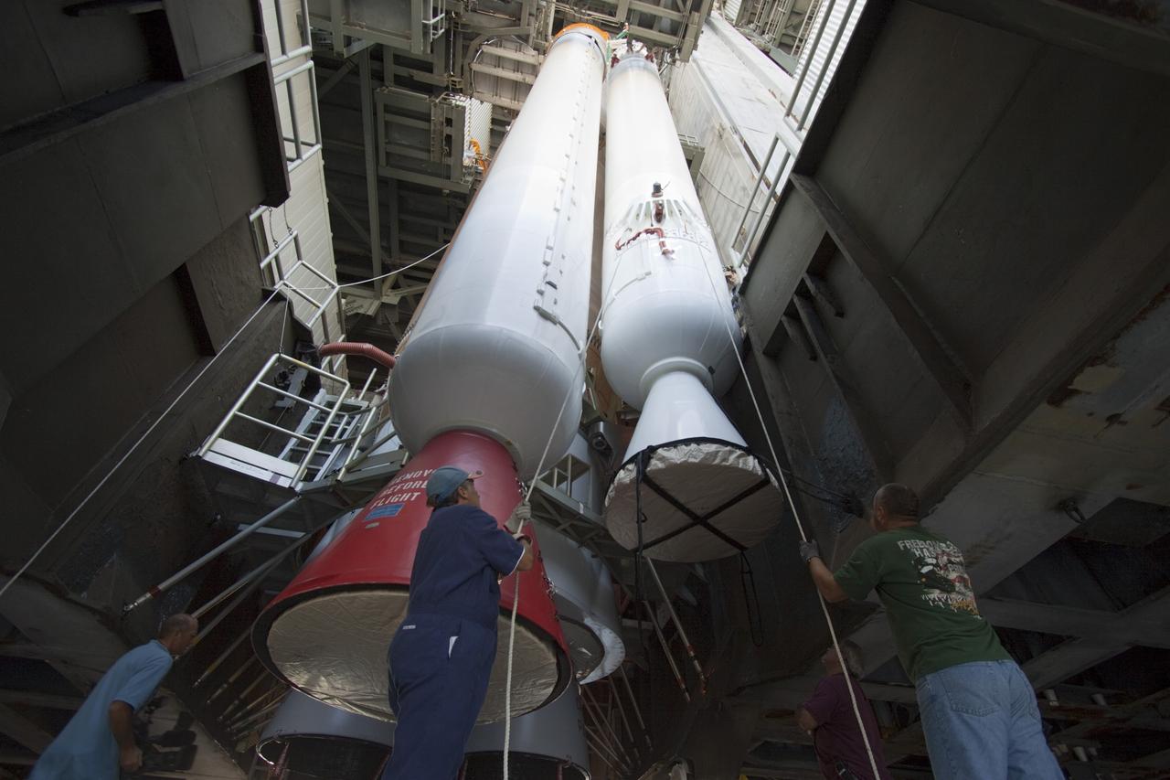 CAPE CANAVERAL, Fla. – Inside the Vertical Integration Facility at Space Launch Complex 41 on Cape Canaveral Air Force Station in Florida, technicians using an overhead crane guide the final solid rocket motor into position for mating to the first stage of a United Launch Alliance Atlas V rocket. The Atlas V will carry NASA's Mars Science Laboratory (MSL) mission into space. MSL's components include a compact car-sized rover, Curiosity, which has 10 science instruments designed to search for evidence on whether Mars has had environments favorable to microbial life, including chemical ingredients for life. The unique rover will use a laser to look inside rocks and release its gasses so that the rover’s spectrometer can analyze and send the data back to Earth. MSL is scheduled to launch Nov. 25 with a window extending to Dec. 18 and arrival at Mars Aug. 2012. For more information, visit http://www.nasa.gov/msl. Photo credit: NASA/Jim Grossmann