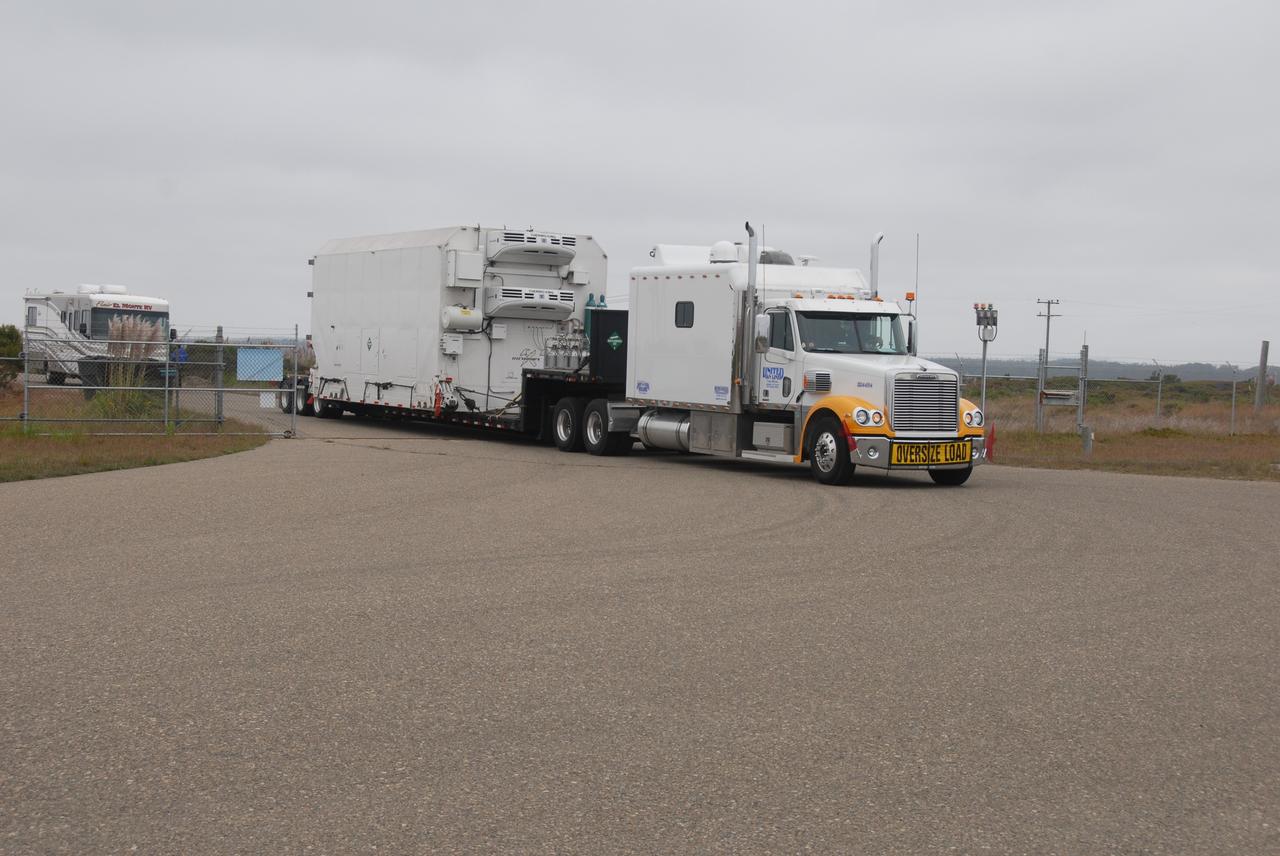 VANDENBERG AIR FORCE BASE, Calif. – Transported by truck, the environmentally controlled transportation container holding NASA’s National Polar-orbiting Operational Environmental Satellite System Preparatory Project (NPP) arrives at the Astrotech Payload Processing Facility at Vandenberg Air Force Base in California.     NPP represents a critical first step in building the next-generation of Earth-observing satellites. NPP will carry the first of the new sensors developed for this satellite fleet, now known as the Joint Polar Satellite System (JPSS), to be launched in 2016. NPP is the bridge between NASA’s Earth Observing System (EOS) satellites and the forthcoming series of JPSS satellites. The mission will test key technologies and instruments for the JPSS missions. NPP is targeted to launch Oct. 25 from Space Launch Complex-2 aboard a United Launch Alliance Delta II rocket. For more information, visit http://www.nasa.gov/NPP. Photo credit: NASA/30th Communications Squadron, VAFB