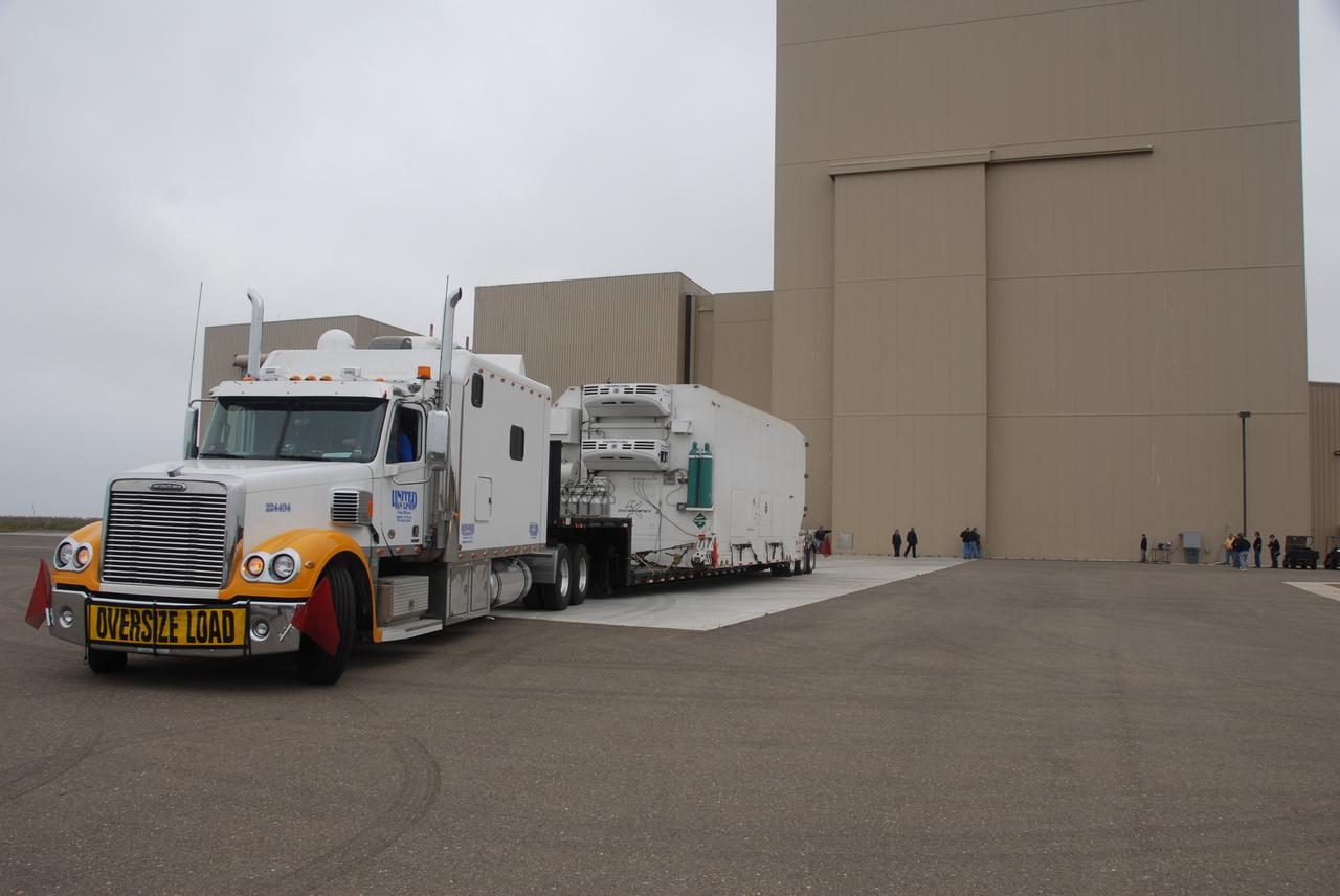 VANDENBERG AIR FORCE BASE, Calif. – Transported by truck, the environmentally controlled transportation container holding NASA’s National Polar-orbiting Operational Environmental Satellite System Preparatory Project (NPP) arrives at the Astrotech Payload Processing Facility at Vandenberg Air Force Base in California.     NPP represents a critical first step in building the next-generation of Earth-observing satellites. NPP will carry the first of the new sensors developed for this satellite fleet, now known as the Joint Polar Satellite System (JPSS), to be launched in 2016. NPP is the bridge between NASA’s Earth Observing System (EOS) satellites and the forthcoming series of JPSS satellites. The mission will test key technologies and instruments for the JPSS missions. NPP is targeted to launch Oct. 25 from Space Launch Complex-2 aboard a United Launch Alliance Delta II rocket. For more information, visit http://www.nasa.gov/NPP. Photo credit: NASA/30th Communications Squadron, VAFB