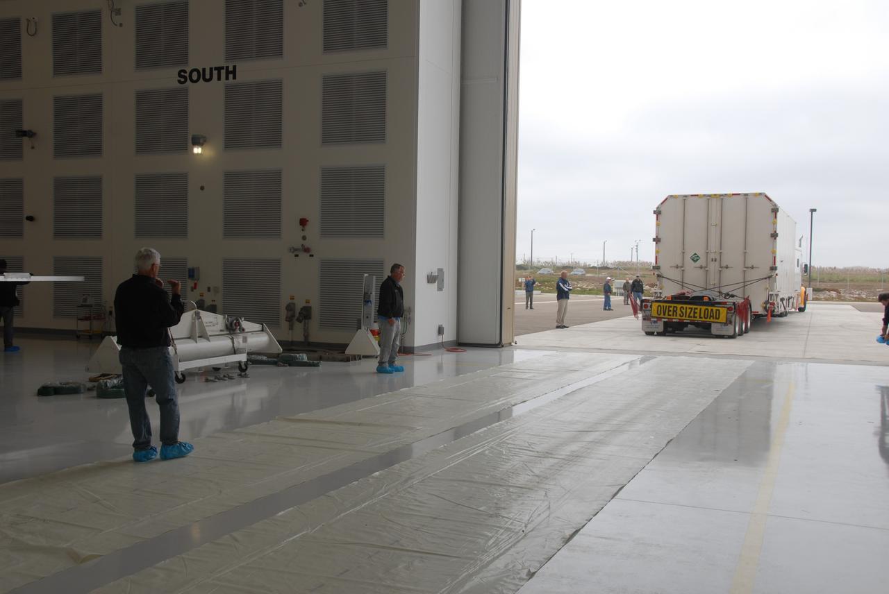 VANDENBERG AIR FORCE BASE, Calif. – Transported by truck, the environmentally controlled transportation container holding NASA’s National Polar-orbiting Operational Environmental Satellite System Preparatory Project (NPP) arrives at the Astrotech Payload Processing Facility at Vandenberg Air Force Base in California.     NPP represents a critical first step in building the next-generation of Earth-observing satellites. NPP will carry the first of the new sensors developed for this satellite fleet, now known as the Joint Polar Satellite System (JPSS), to be launched in 2016. NPP is the bridge between NASA’s Earth Observing System (EOS) satellites and the forthcoming series of JPSS satellites. The mission will test key technologies and instruments for the JPSS missions. NPP is targeted to launch Oct. 25 from Space Launch Complex-2 aboard a United Launch Alliance Delta II rocket. For more information, visit http://www.nasa.gov/NPP. Photo credit: NASA/30th Communications Squadron, VAFB