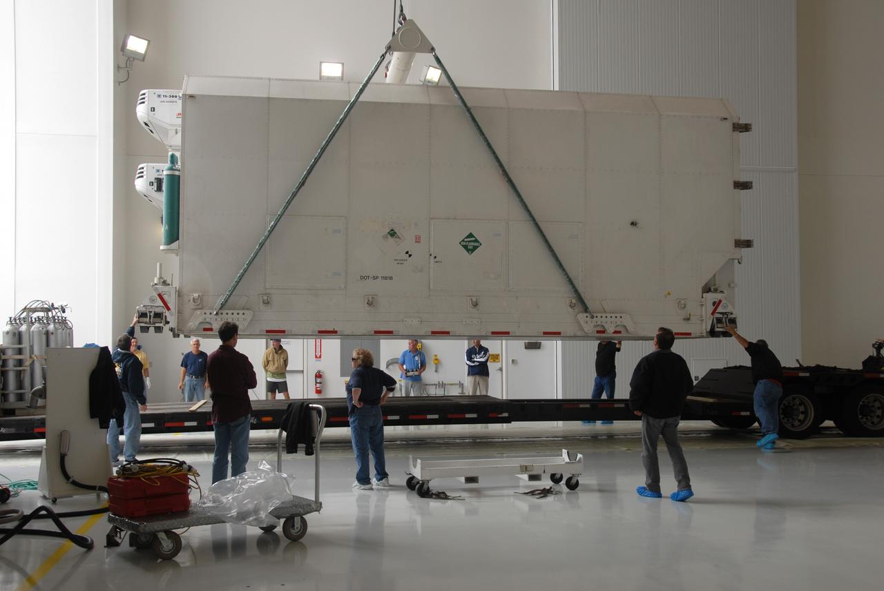 VANDENBERG AIR FORCE BASE, Calif. – In the Astrotech Payload Processing Facility at Vandenberg Air Force Base in California, technicians monitor the progress as a crane begins to lift the container holding NASA’s National Polar-orbiting Operational Environmental Satellite System Preparatory Project (NPP). NPP represents a critical first step in building the next-generation of Earth-observing satellites. NPP will carry the first of the new sensors developed for this satellite fleet, now known as the Joint Polar Satellite System (JPSS), to be launched in 2016. NPP is the bridge between NASA’s Earth Observing System (EOS) satellites and the forthcoming series of JPSS satellites. The mission will test key technologies and instruments for the JPSS missions. NPP is targeted to launch Oct. 25 from Space Launch Complex-2 aboard a United Launch Alliance Delta II rocket. For more information, visit http://www.nasa.gov/NPP. Photo credit: NASA/30th Communications Squadron, VAFB