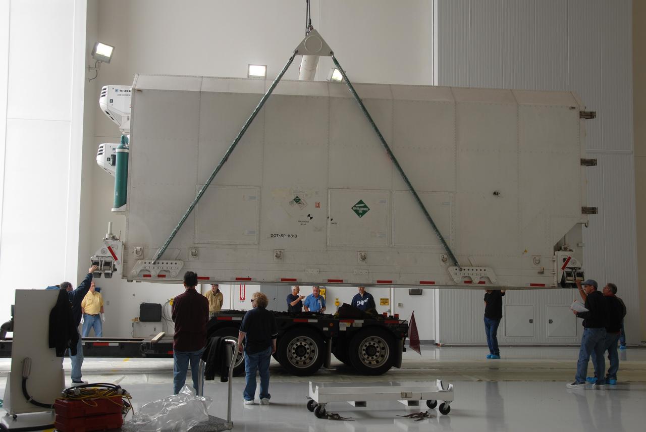 VANDENBERG AIR FORCE BASE, Calif. – In the Astrotech Payload Processing Facility at Vandenberg Air Force Base in California, technicians monitor the progress as a crane begins to lift the container holding NASA’s National Polar-orbiting Operational Environmental Satellite System Preparatory Project (NPP). NPP represents a critical first step in building the next-generation of Earth-observing satellites. NPP will carry the first of the new sensors developed for this satellite fleet, now known as the Joint Polar Satellite System (JPSS), to be launched in 2016. NPP is the bridge between NASA’s Earth Observing System (EOS) satellites and the forthcoming series of JPSS satellites. The mission will test key technologies and instruments for the JPSS missions. NPP is targeted to launch Oct. 25 from Space Launch Complex-2 aboard a United Launch Alliance Delta II rocket. For more information, visit http://www.nasa.gov/NPP. Photo credit: NASA/30th Communications Squadron, VAFB