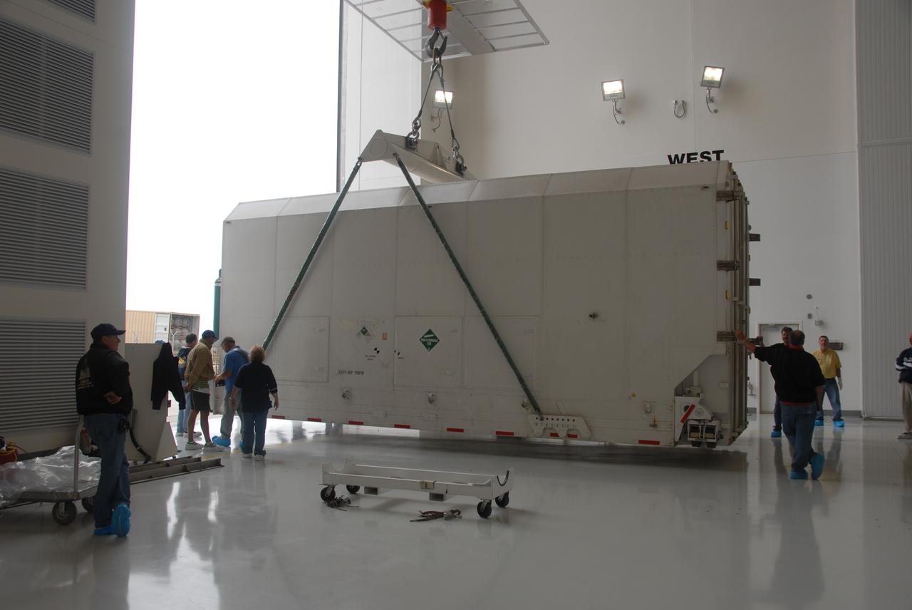 VANDENBERG AIR FORCE BASE, Calif. – In the Astrotech Payload Processing Facility at Vandenberg Air Force Base in California, technicians monitor the progress as a crane begins to lift the container holding NASA’s National Polar-orbiting Operational Environmental Satellite System Preparatory Project (NPP).    NPP represents a critical first step in building the next-generation of Earth-observing satellites. NPP will carry the first of the new sensors dev eloped for this satellite fleet, now known as the Joint Polar Satellite System (JPSS), to be launched in 2016. NPP is the bridge between NASA’s Earth Observing System (EOS) satellites and the forthcoming series of JPSS satellites. The mission will test key technologies and instruments for the JPSS missions. NPP is targeted to launch Oct. 25 from Space Launch Complex-2 aboard a United Launch Alliance Delta II rocket. For more information, visit http://www.nasa.gov/NPP. Photo credit: NASA/30th Communications Squadron, VAFB