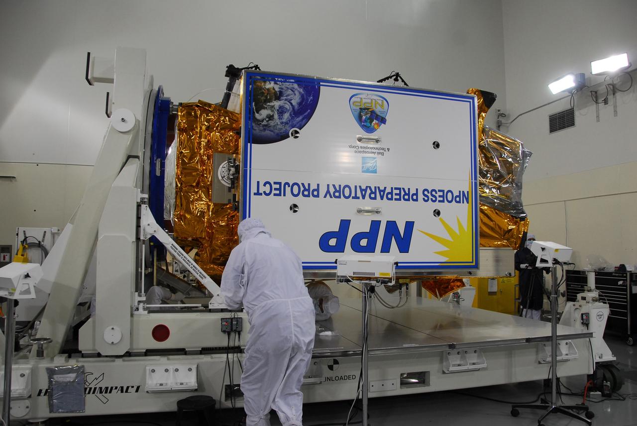 VANDENBERG AIR FORCE BASE, Calif. – In a clean room inside the Astrotech Payload Processing Facility at Vandenberg Air Force Base in California, technicians position NASA’s National Polar-orbiting Operational Environmental Satellite System Preparatory Project (NPP) for test and checkout. NPP represents a critical first step in building the next-generation of Earth-observing satellites. NPP will carry the first of the new sensors developed for this satellite fleet, now known as the Joint Polar Satellite System (JPSS), to be launched in 2016. NPP is the bridge between NASA’s Earth Observing System (EOS) satellites and the forthcoming series of JPSS satellites. The mission will test key technologies and instruments for the JPSS missions. NPP is targeted to launch Oct. 25 from Space Launch Complex-2 aboard a United Launch Alliance Delta II rocket. For more information, visit http://www.nasa.gov/NPP. Photo credit: NASA/30th Communications Squadron, VAFB