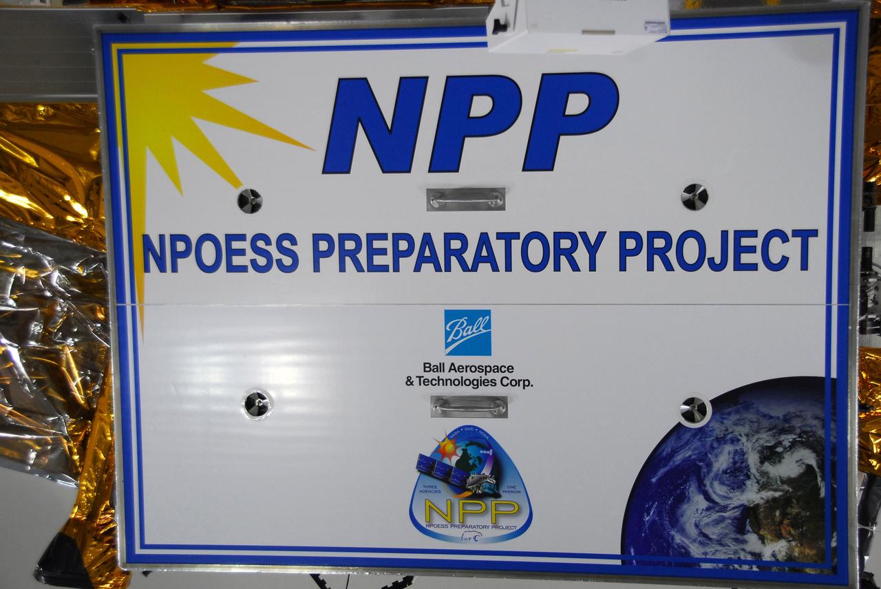 VANDENBERG AIR FORCE BASE, Calif. – In a clean room inside the Astrotech Payload Processing Facility at Vandenberg Air Force Base in California, a large sign is placed on the test stand holding NASA’s National Polar-orbiting Operational Environmental Satellite System Preparatory Project (NPP). The satellite system is awaiting test and checkout procedures to prepare it for launch. NPP represents a critical first step in building the next-generation of Earth-observing satellites. NPP will carry the first of the new sensors developed for this satellite fleet, now known as the Joint Polar Satellite System (JPSS), to be launched in 2016. NPP is the bridge between NASA’s Earth Observing System (EOS) satellites and the forthcoming series of JPSS satellites. The mission will test key technologies and instruments for the JPSS missions. NPP is targeted to launch Oct. 25 from Space Launch Complex-2 aboard a United Launch Alliance Delta II rocket. For more information, visit http://www.nasa.gov/NPP. Photo credit: NASA/30th Communications Squadron, VAFB
