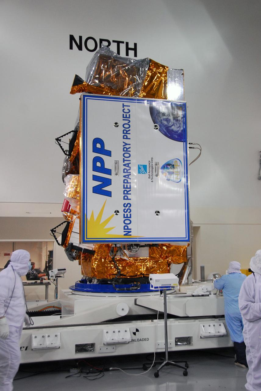 VANDENBERG AIR FORCE BASE, Calif. – In a clean room inside the Astrotech Payload Processing Facility at Vandenberg Air Force Base in California, Ball Aerospace technicians rotate NASA’s National Polar-orbiting Operational Environmental Satellite System Preparatory Project (NPP) into the vertical position during a solar array frangible bolt pre-load verification test. NPP represents a critical first step in building the next-generation of Earth-observing satellites. NPP will carry the first of the new sensors developed for this satellite fleet, now known as the Joint Polar Satellite System (JPSS), to be launched in 2016. NPP is the bridge between NASA’s Earth Observing System (EOS) satellites and the forthcoming series of JPSS satellites. The mission will test key technologies and instruments for the JPSS missions. NPP is targeted to launch Oct. 25 from Space Launch Complex-2 aboard a United Launch Alliance Delta II rocket. For more information, visit http://www.nasa.gov/NPP. Photo credit: NASA/30th Communications Squadron, VAFB