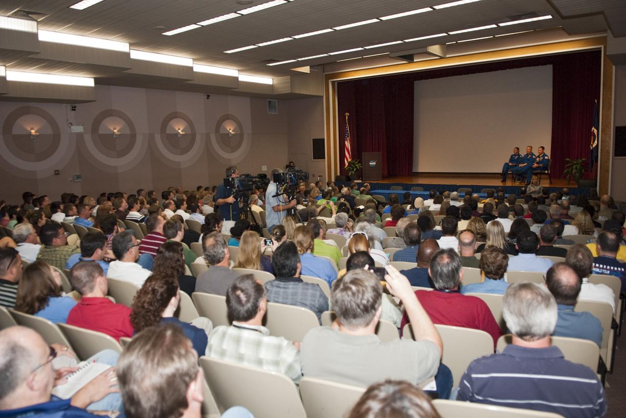 CAPE CANAVERAL, Fla. – Astronauts from space shuttle Atlantis’ STS-135 mission return to the Training Auditorium at NASA’s Kennedy Space Center for the traditional post-flight crew return presentation. Having completed their successful 13-day mission to the International Space Station, (from left) Mission Specialist Sandra Magnus, Pilot Doug Hurley and Commander Chris Ferguson share personal stories of their experiences.    STS-135 Mission Specialist Rex Walheim was unable to attend the Kennedy event. In July 2011, Atlantis and its crew delivered to the International Space Station the Raffaello multi-purpose logistics module packed with more than 9,400 pounds of spare parts, equipment and supplies that will sustain station operations for the next year. STS-135 was the 33rd and final flight for Atlantis and the final mission of the Space Shuttle Program. For more information, visit www.nasa.gov/mission_pages/shuttle/shuttlemissions/sts135/index.html. Photo credit: NASA/Jim Grossmann