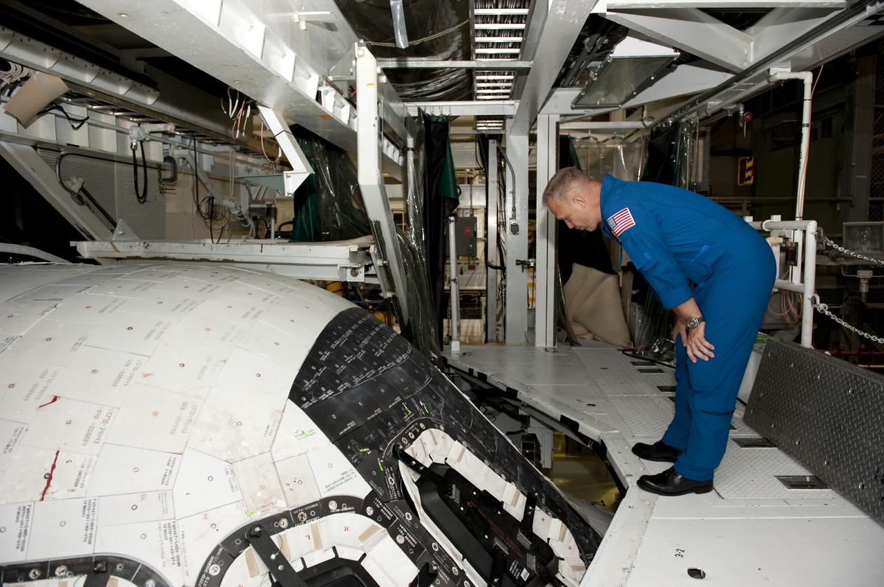 CAPE CANAVERAL, Fla. – Inside Kennedy Space Center's Orbiter Processing Facility-2, STS-135 Pilot Doug Hurley inspects the windows on space shuttle Atlantis. Atlantis is being prepared for eventual display at the Kennedy Space Center Visitor Complex in Florida. Hurley, along with Commander Chris Ferguson and Mission Specialist Sandra Magnus, was at the center for the traditional post-flight crew return presentation.      STS-135 Mission Specialist Rex Walheim was unable to attend the Kennedy event. In July 2011, Atlantis and its crew delivered to the International Space Station the Raffaello multi-purpose logistics module packed with more than 9,400 pounds of spare parts, equipment and supplies that will sustain station operations for the next year. STS-135 was the 33rd and final flight for Atlantis and the final mission of the Space Shuttle Program. For more information, visit www.nasa.gov/mission_pages/shuttle/shuttlemissions/sts135/index.html. Photo credit: NASA/Kim Shiflett