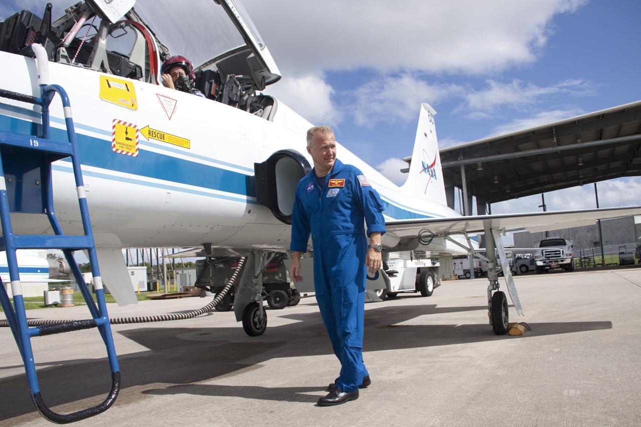 CAPE CANAVERAL, Fla. – At the Shuttle Landing Facility at NASA's Kennedy Space Center in Florida, STS-135 Pilot Doug Hurley and Mission Specialist Sandra Magnus (in the red helmet) prepare for departure in a T-38 training jet. The astronauts, along with Commander Chris Ferguson, were at the center for the traditional post-flight crew return presentation. STS-135 Mission Specialist Rex Walheim was unable to attend the Kennedy event. In July 2011, Atlantis and its crew delivered to the International Space Station the Raffaello multi-purpose logistics module packed with more than 9,400 pounds of spare parts, equipment and supplies that will sustain station operations for the next year. STS-135 was the 33rd and final flight for Atlantis and the final mission of the Space Shuttle Program. For more information, visit www.nasa.gov/mission_pages/shuttle/shuttlemissions/sts135/index.html. Photo credit: NASA/Jim Grossmann