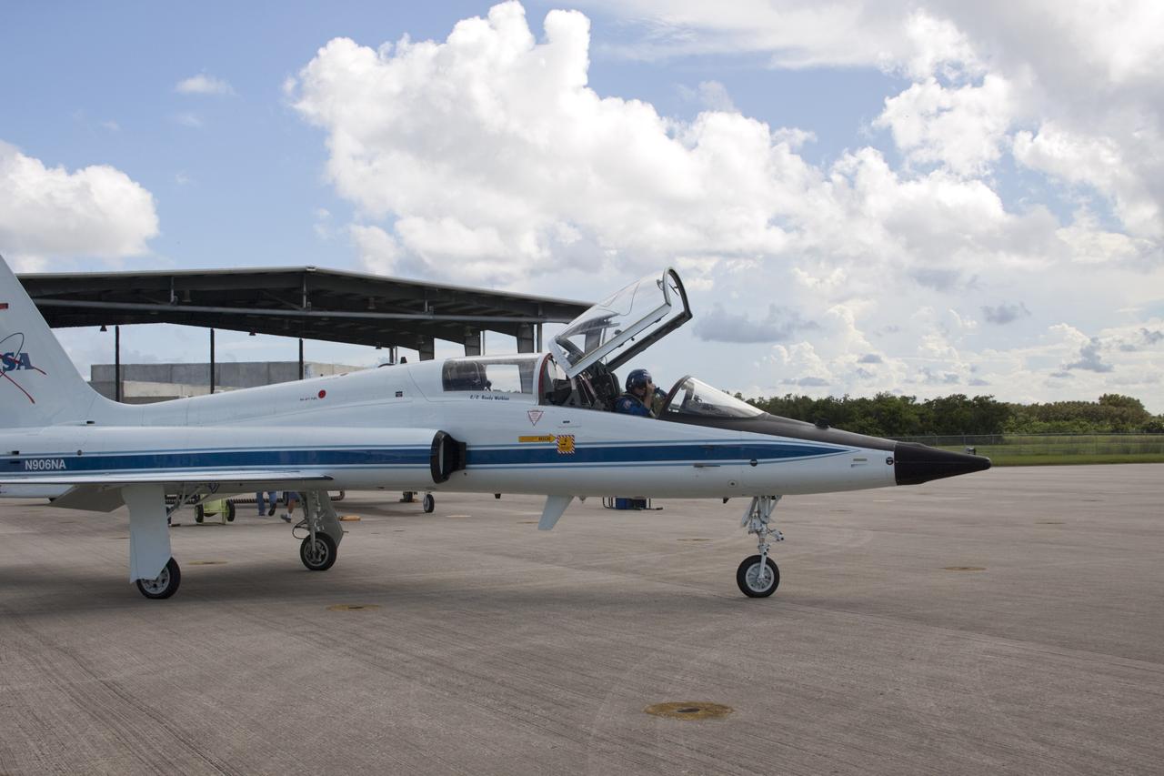 CAPE CANAVERAL, Fla. – At the Shuttle Landing Facility at NASA's Kennedy Space Center in Florida, STS-135 Pilot Doug Hurley and Mission Specialist Sandra Magnus (in the red helmet) prepare for departure in a T-38 training jet. The astronauts, along with Commander Chris Ferguson, were at the center for the traditional post-flight crew return presentation. STS-135 Mission Specialist Rex Walheim was unable to attend the Kennedy event. In July 2011, Atlantis and its crew delivered to the International Space Station the Raffaello multi-purpose logistics module packed with more than 9,400 pounds of spare parts, equipment and supplies that will sustain station operations for the next year. STS-135 was the 33rd and final flight for Atlantis and the final mission of the Space Shuttle Program. For more information, visit www.nasa.gov/mission_pages/shuttle/shuttlemissions/sts135/index.html. Photo credit: NASA/Jim Grossmann