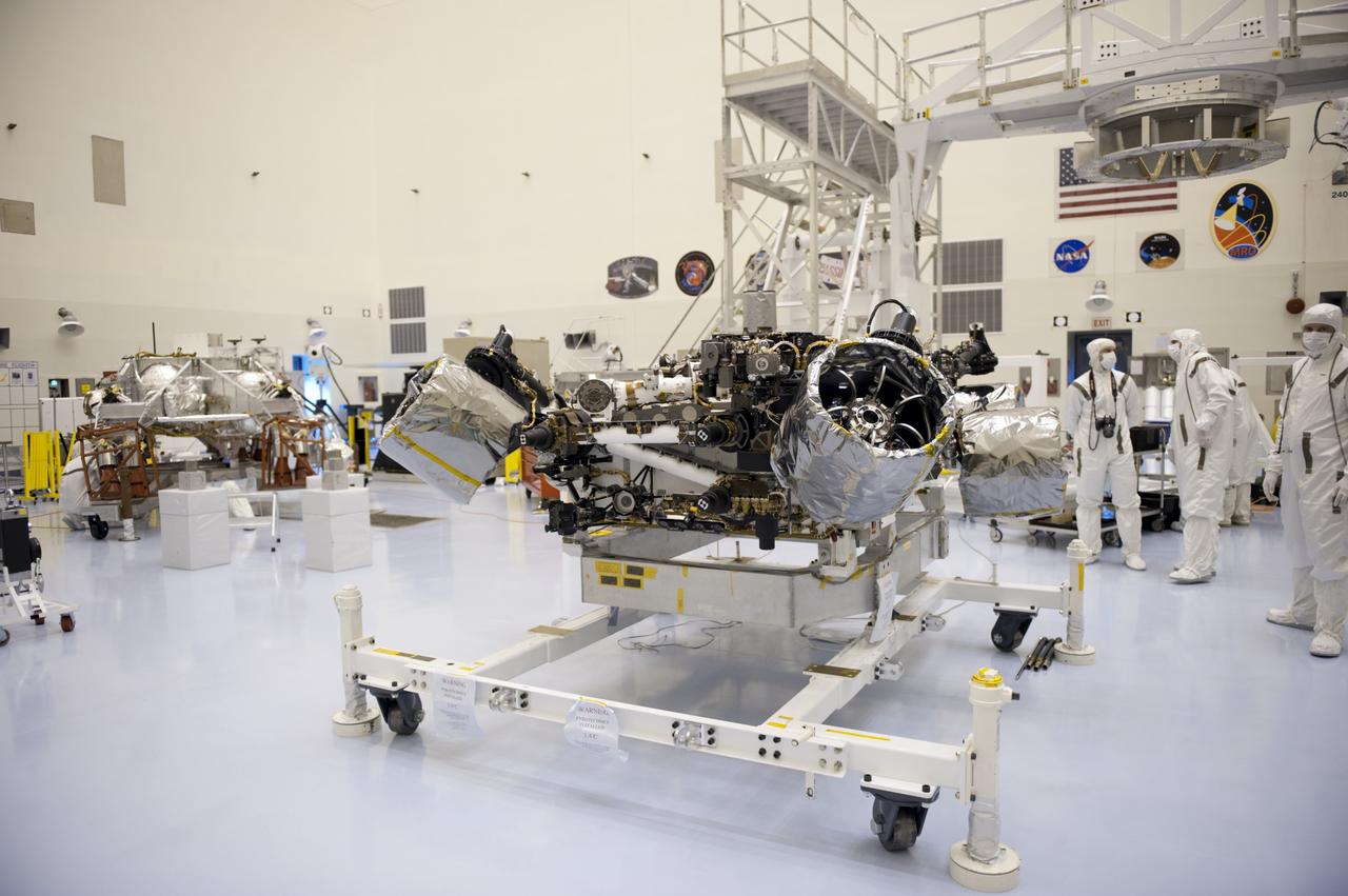CAPE CANAVERAL, Fla. – At the Payload Hazardous Servicing Facility at NASA’s Kennedy Space Center in Florida, NASA's Mars Science Laboratory (MSL) rover, known as Curiosity, will be integrated with a rocket-powered descent stage (shown here to the left of the rover). The descent stage will lower Curiosity to the surface of Mars.     A United Launch Alliance Atlas V-541 configuration will be used to loft MSL into space. Curiosity’s 10 science instruments are designed to search for evidence on whether Mars has had environments favorable to microbial life, including chemical ingredients for life.  The unique rover will use a laser to look inside rocks and release its gasses so that the rover’s spectrometer can analyze and send the data back to Earth. MSL is scheduled to launch Nov. 25 with a window extending to Dec. 18 and arrival at Mars Aug. 2012. For more information, visit http://www.nasa.gov/msl. Photo credit: NASA/Kim Shiflett