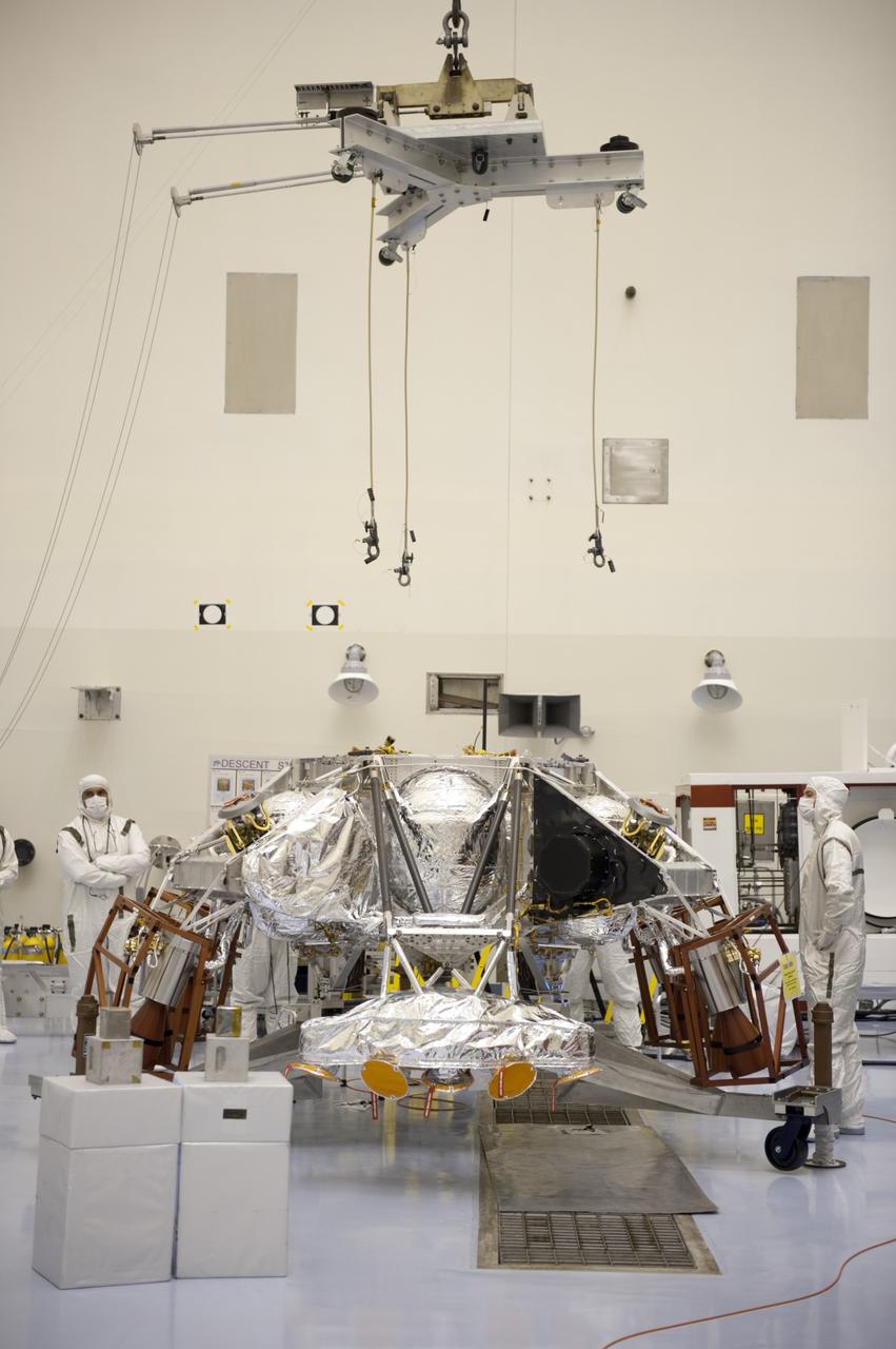 CAPE CANAVERAL, Fla. – At the Payload Hazardous Servicing Facility at NASA’s Kennedy Space Center in Florida, an overhead crane is being lowered over a rocket-powered descent stage for integration with NASA's Mars Science Laboratory (MSL) rover, known as Curiosity. The descent stage will lower Curiosity to the surface of Mars.     A United Launch Alliance Atlas V-541 configuration will be used to loft MSL into space. Curiosity’s 10 science instruments are designed to search for evidence on whether Mars has had environments favorable to microbial life, including chemical ingredients for life.  The unique rover will use a laser to look inside rocks and release its gasses so that the rover’s spectrometer can analyze and send the data back to Earth. MSL is scheduled to launch Nov. 25 with a window extending to Dec. 18 and arrival at Mars Aug. 2012. For more information, visit http://www.nasa.gov/msl. Photo credit: NASA/Kim Shiflett