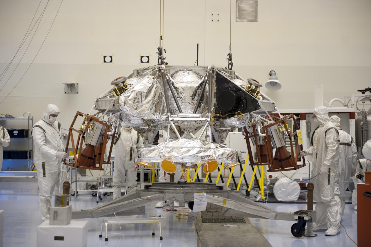 CAPE CANAVERAL, Fla. – At the Payload Hazardous Servicing Facility at NASA’s Kennedy Space Center in Florida, technicians carefully monitor the attachment of an overhead crane to a rocket-powered descent stage which will be integrated with NASA's Mars Science Laboratory (MSL) rover, known as Curiosity. The descent stage will lower Curiosity to the surface of Mars.     A United Launch Alliance Atlas V-541 configuration will be used to loft MSL into space. Curiosity’s 10 science instruments are designed to search for evidence on whether Mars has had environments favorable to microbial life, including chemical ingredients for life.  The unique rover will use a laser to look inside rocks and release its gasses so that the rover’s spectrometer can analyze and send the data back to Earth. MSL is scheduled to launch Nov. 25 with a window extending to Dec. 18 and arrival at Mars Aug. 2012. For more information, visit http://www.nasa.gov/msl. Photo credit: NASA/Kim Shiflett