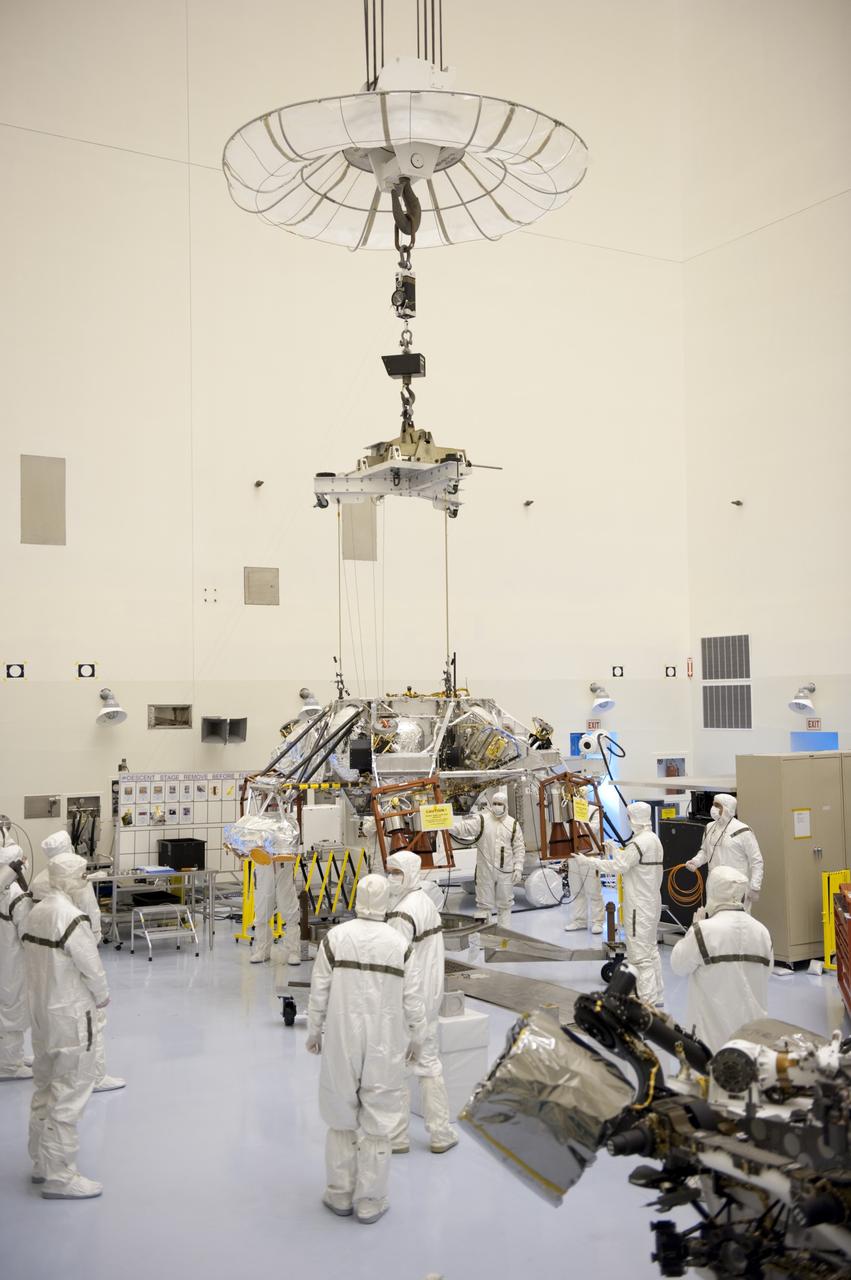 CAPE CANAVERAL, Fla. – Technicians, at the Payload Hazardous Servicing Facility at NASA's Kennedy Space Center in Florida, use an overhead crane to move a rocket-powered descent stage for integration with NASA's Mars Science Laboratory (MSL) rover, known as Curiosity. The descent stage will lower Curiosity to the surface of Mars.     A United Launch Alliance Atlas V-541 configuration will be used to loft MSL into space. Curiosity’s 10 science instruments are designed to search for evidence on whether Mars has had environments favorable to microbial life, including chemical ingredients for life.  The unique rover will use a laser to look inside rocks and release its gasses so that the rover’s spectrometer can analyze and send the data back to Earth. MSL is scheduled to launch Nov. 25 with a window extending to Dec. 18 and arrival at Mars Aug. 2012. For more information, visit http://www.nasa.gov/msl. Photo credit: NASA/Kim Shiflett