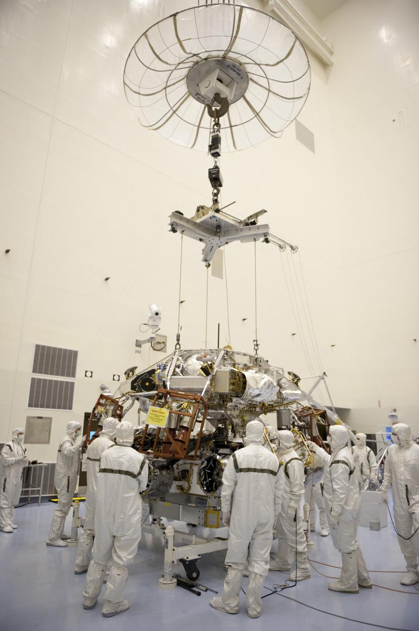 CAPE CANAVERAL, Fla. – Under the watchful eyes of technicians at the Payload Hazardous Servicing Facility at NASA's Kennedy Space Center in Florida, a rocket-powered descent stage, after being lowered by an overhead crane, is integrated with NASA's Mars Science Laboratory (MSL) rover, known as Curiosity. The descent stage will lower Curiosity to the surface of Mars.     A United Launch Alliance Atlas V-541 configuration will be used to loft MSL into space. Curiosity’s 10 science instruments are designed to search for evidence on whether Mars has had environments favorable to microbial life, including chemical ingredients for life.  The unique rover will use a laser to look inside rocks and release its gasses so that the rover’s spectrometer can analyze and send the data back to Earth. MSL is scheduled to launch Nov. 25 with a window extending to Dec. 18 and arrival at Mars Aug. 2012. For more information, visit http://www.nasa.gov/msl. Photo credit: NASA/Kim Shiflett