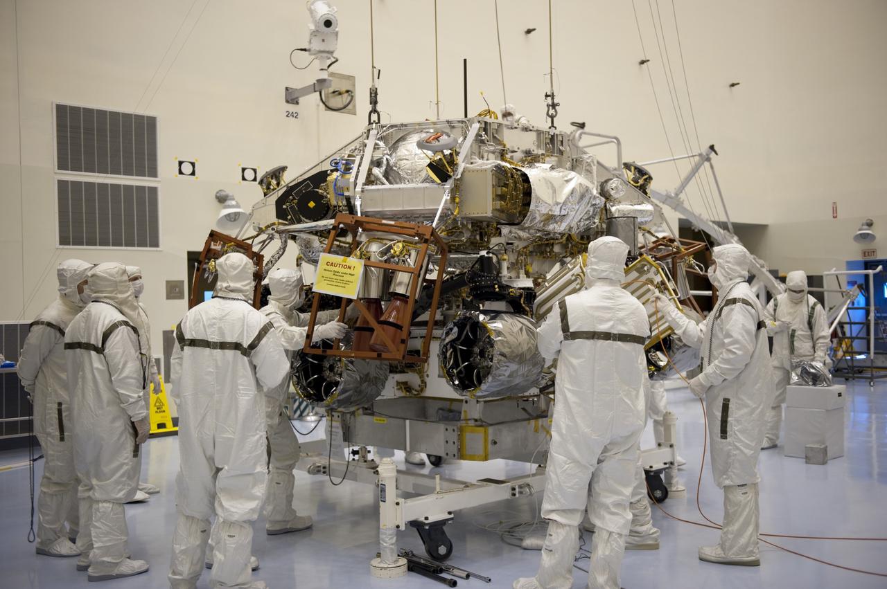 CAPE CANAVERAL, Fla. – Under the watchful eyes of technicians at the Payload Hazardous Servicing Facility at NASA's Kennedy Space Center in Florida, a rocket-powered descent stage, after being lowered by an overhead crane, is integrated with NASA's Mars Science Laboratory (MSL) rover, known as Curiosity. The descent stage will lower Curiosity to the surface of Mars.     A United Launch Alliance Atlas V-541 configuration will be used to loft MSL into space. Curiosity’s 10 science instruments are designed to search for evidence on whether Mars has had environments favorable to microbial life, including chemical ingredients for life.  The unique rover will use a laser to look inside rocks and release its gasses so that the rover’s spectrometer can analyze and send the data back to Earth. MSL is scheduled to launch Nov. 25 with a window extending to Dec. 18 and arrival at Mars Aug. 2012. For more information, visit http://www.nasa.gov/msl. Photo credit: NASA/Kim Shiflett
