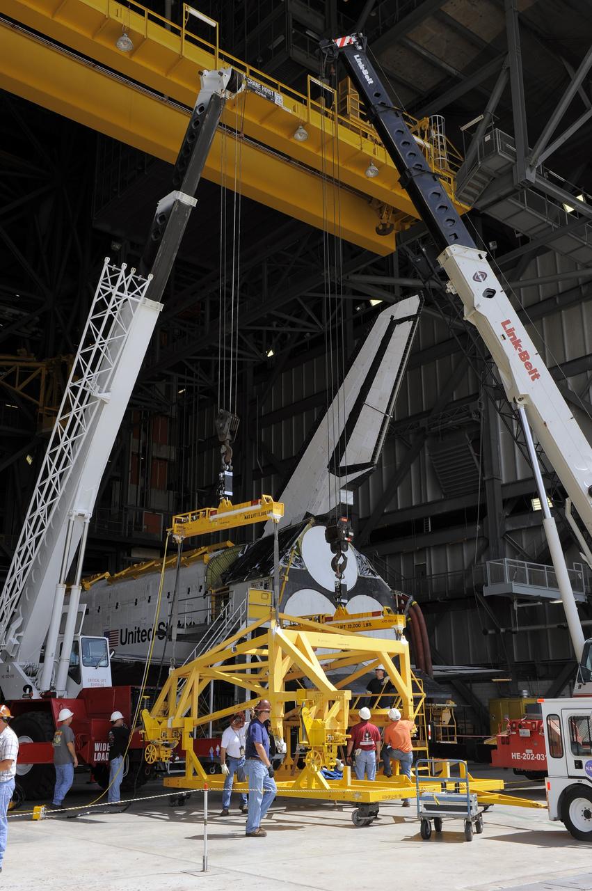 CAPE CANAVERAL, Fla. – In the Vehicle Assembly Building at NASA's Kennedy Space Center in Florida, workers, using overhead cranes, begin to raise a cage which will be placed over an Approach and Landing Test Assembly (ALTA) pod. The ALTA pod will be lifted for attachment to space shuttle Endeavour on the site once housing the orbital maneuvering system (OMS) pod. The demonstration test is being conducted to ensure the center’s equipment will fit into the hangar at the National Air and Space Museum when installing an ALTA pod on shuttle Enterprise. The pod must be reinstalled on a shuttle for transport on a 747 carrier aircraft. The simulation also tests procedures and timelines necessary to carry out the process.       The work is part of the Space Shuttle Program’s transition and retirement processing. Enterprise, which was not equipped for space flight, was built as a test vehicle to demonstrate that the orbiter could fly in the atmosphere and land like an airplane. In 1985, Enterprise was ferried from the Kennedy Space Center to Dulles Airport, Washington, D.C., and became the property of the Smithsonian Institute. Enterprise will be moved from the Smithsonian Institution National Air and Space Museum's Steven F. Udvar-Hazy Center in Chantilly, Va., to the Intrepid Sea, Air and Space Museum in New York. For more information, visit http://www.nasa.gov/shuttle. Photo credit: NASA/Ken Shiflett