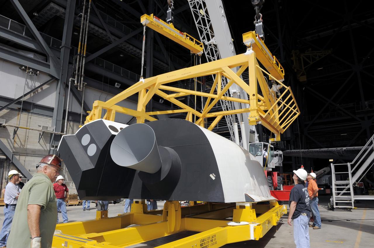 CAPE CANAVERAL, Fla. – In the Vehicle Assembly Building at NASA's Kennedy Space Center in Florida, workers, using overhead cranes, raise a cage over an Approach and Landing Test Assembly (ALTA) pod. The ALTA pod will be lifted for attachment to space shuttle Endeavour on the site once housing the orbital maneuvering system (OMS) pod. The demonstration test is being conducted to ensure the center’s equipment will fit into the hangar at the National Air and Space Museum when installing an ALTA pod on shuttle Enterprise. The pod must be reinstalled on a shuttle for transport on a 747 carrier aircraft. The simulation also tests procedures and timelines necessary to carry out the process.       The work is part of the Space Shuttle Program’s transition and retirement processing. Enterprise, which was not equipped for space flight, was built as a test vehicle to demonstrate that the orbiter could fly in the atmosphere and land like an airplane. In 1985, Enterprise was ferried from the Kennedy Space Center to Dulles Airport, Washington, D.C., and became the property of the Smithsonian Institute. Enterprise will be moved from the Smithsonian Institution National Air and Space Museum's Steven F. Udvar-Hazy Center in Chantilly, Va., to the Intrepid Sea, Air and Space Museum in New York. For more information, visit http://www.nasa.gov/shuttle. Photo credit: NASA/Ken Shiflett