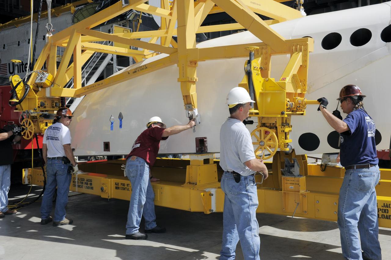 CAPE CANAVERAL, Fla. – In the Vehicle Assembly Building at NASA's Kennedy Space Center in Florida, workers, using overhead cranes, lower a cage over an Approach and Landing Test Assembly (ALTA) pod. The ALTA pod will be lifted for attachment to space shuttle Endeavour on the site once housing the orbital maneuvering system (OMS) pod. The demonstration test is being conducted to ensure the center’s equipment will fit into the hangar at the National Air and Space Museum when installing an ALTA pod on shuttle Enterprise. The pod must be reinstalled on a shuttle for transport on a 747 carrier aircraft. The simulation also tests procedures and timelines necessary to carry out the process.       The work is part of the Space Shuttle Program’s transition and retirement processing. Enterprise, which was not equipped for space flight, was built as a test vehicle to demonstrate that the orbiter could fly in the atmosphere and land like an airplane. In 1985, Enterprise was ferried from the Kennedy Space Center to Dulles Airport, Washington, D.C., and became the property of the Smithsonian Institute. Enterprise will be moved from the Smithsonian Institution National Air and Space Museum's Steven F. Udvar-Hazy Center in Chantilly, Va., to the Intrepid Sea, Air and Space Museum in New York. For more information, visit http://www.nasa.gov/shuttle. Photo credit: NASA/Ken Shiflett