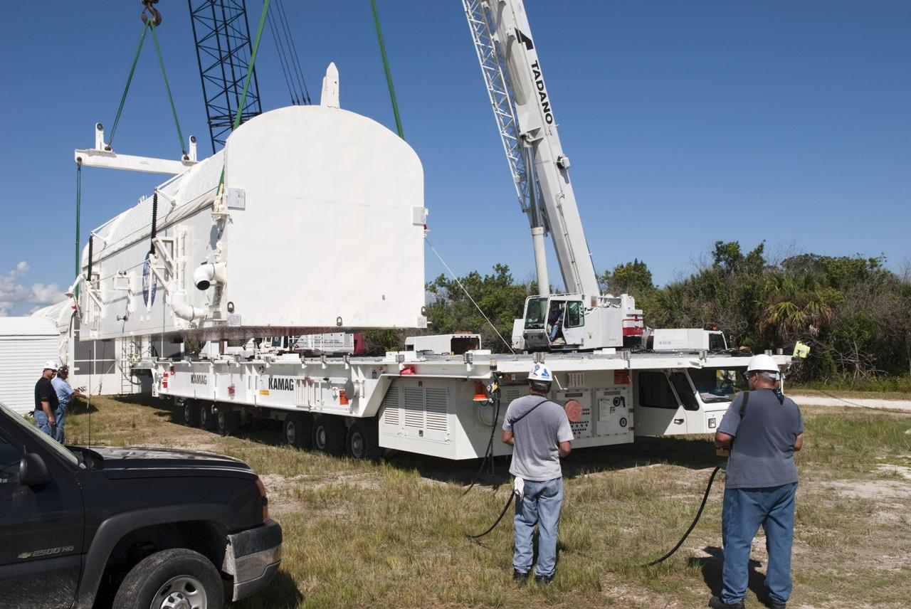 CAPE CANAVERAL, Fla. -- Cranes lift payload canister #2 from the transporter that delivered it to the Reutilization, Recycling and Marketing Facility on Ransom Road at NASA's Kennedy Space Center in Florida.      The two payload canisters used to transport space shuttle payloads to the launch pad for installation in the shuttles' cargo bays are being decommissioned following the end of the Space Shuttle Program. Each canister weighs 110,000 pounds and is 65 feet long, 22 feet wide, and 18 feet, 7 inches high.  The canisters were prescreened through NASA Headquarters as possible artifacts, but their size makes them difficult to transport to locations off the center. Federal and state agencies now will be given the opportunity to screen the canisters for potential use before a final decision is made on their disposition.  For more information, visit http://www.nasa.gov/centers/kennedy/pdf/167403main_CRF-06.pdf. Photo credit: NASA/Jim Grossmann
