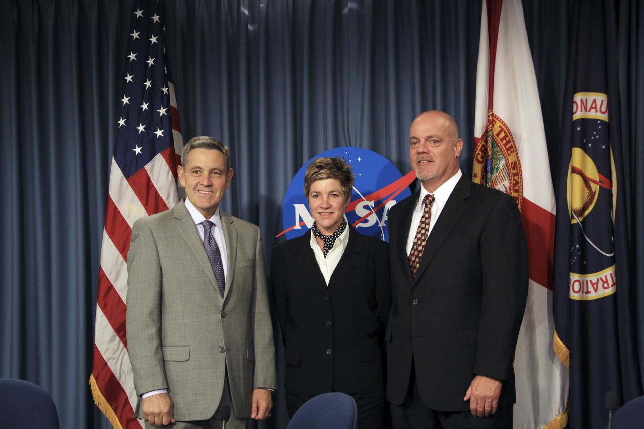 CAPE CANAVERAL, Fla. -- In the Press Site auditorium at NASA's Kennedy Space Center in Florida, managers from NASA and the Economic Development Commission (EDC) of Florida’s Space Coast pose for a portrait following the signing of a new five-year Space Act Agreement reaffirming the partnership of the two organizations.  From left are Kennedy Space Center Director Robert Cabana, EDC President and CEO Lynda Weatherman, and Chairman of the Board of the EDC Bob Whelen.    The agreement calls for NASA and EDC senior leadership to meet regularly to discuss economic development matters of mutual interest. Managers from Kennedy’s Center Planning and Development Office will work with the EDC on potential business partnerships and meet with business leaders and committees to address space-related and high-tech economic development. EDC officials will assist NASA with disseminating information about potential partnership opportunities, as well as space-related and high-tech economic development, and increase awareness of Kennedy’s Engineering and Technology Directorate collaboration initiatives. They also will promote the commercial use of underutilized facilities at Kennedy. NASA and the EDC entered into their first economic cooperation agreement in 2005.  For more information about the Economic Development Commission (EDC) of Florida’s Space Coast, visit http://www.spacecoastedc.org/. Photo credit: NASA/Jim Grossmann