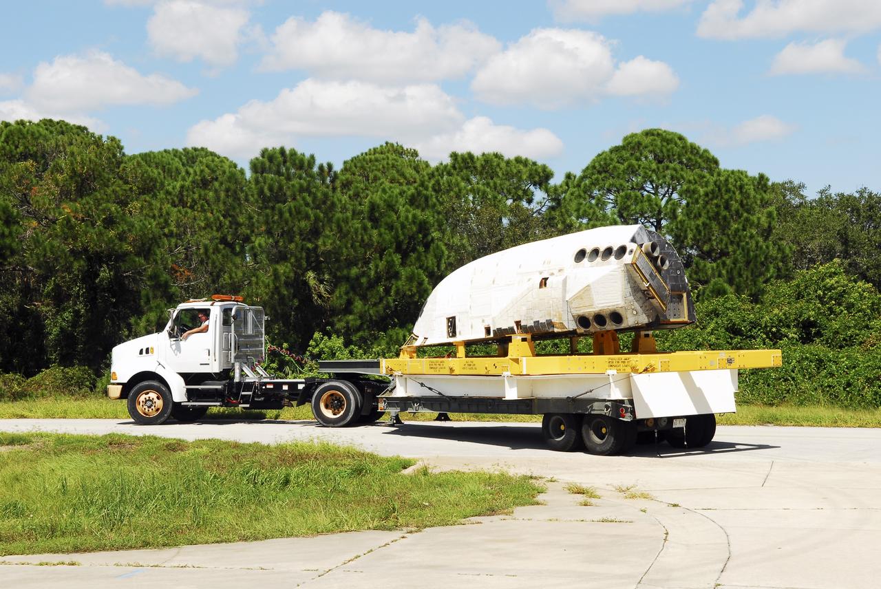 CAPE CANAVERAL, Fla. – At NASA’s Kennedy Space Center in Florida, a truck transports space shuttle Discovery's orbital maneuvering system (OMS) pod from the Hypergol Maintenance Facility to the Orbiter Processing Facility (OPF). The OMS has been returned from White Sands Space Harbor in New Mexico where it underwent a complete deservicing and cleaning.        The work is part of the Space Shuttle Program’s transition and retirement processing of space shuttle Discovery. The shuttle will go to the Smithsonian's National Air and Space Museum, Steven F. Udvar-Hazy Center in Chantilly, Va. For more information, visit http://www.nasa.gov/shuttle. Photo credit: NASA/Jim Grossmann