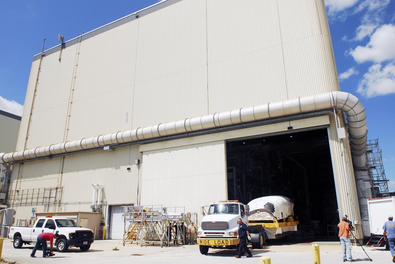 CAPE CANAVERAL, Fla. – At NASA’s Kennedy Space Center in Florida, a truck backs space shuttle Discovery's orbital maneuvering system (OMS) pod into Orbiter Processing Facility-1 (OPF). The OMS has been returned from White Sands Space Harbor in New Mexico where it underwent a complete deservicing and cleaning.         The work is part of the Space Shuttle Program’s transition and retirement processing of space shuttle Discovery. The shuttle will go to the Smithsonian's National Air and Space Museum, Steven F. Udvar-Hazy Center in Chantilly, Va. For more information, visit http://www.nasa.gov/shuttle. Photo credit: NASA/Jim Grossmann