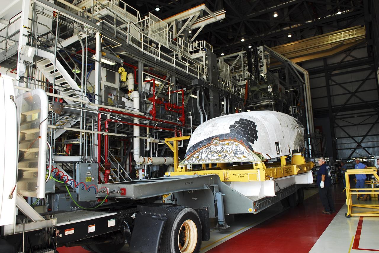 CAPE CANAVERAL, Fla. – At NASA’s Kennedy Space Center in Florida, a truck positions space shuttle Discovery's orbital maneuvering system (OMS) pod into Orbiter Processing Facility-1 (OPF). The OMS has been returned from White Sands Space Harbor in New Mexico where it underwent a complete deservicing and cleaning.          The work is part of the Space Shuttle Program’s transition and retirement processing of space shuttle Discovery. The shuttle will go to the Smithsonian's National Air and Space Museum, Steven F. Udvar-Hazy Center in Chantilly, Va. For more information, visit http://www.nasa.gov/shuttle. Photo credit: NASA/Jim Grossmann