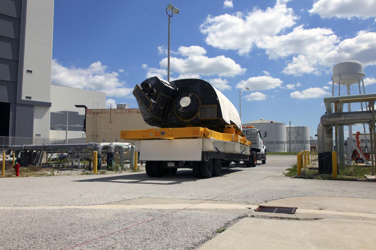 CAPE CANAVERAL, Fla. – At NASA’s Kennedy Space Center in Florida, a truck transports space shuttle Discovery's orbital maneuvering system (OMS) pod to the Orbiter Processing Facility (OPF). The OMS has been returned from White Sands Space Harbor in New Mexico where it underwent a complete deservicing and cleaning.        The work is part of the Space Shuttle Program’s transition and retirement processing of space shuttle Discovery. The shuttle will go to the Smithsonian's National Air and Space Museum, Steven F. Udvar-Hazy Center in Chantilly, Va. For more information, visit http://www.nasa.gov/shuttle. Photo credit: NASA/Frankie Martin