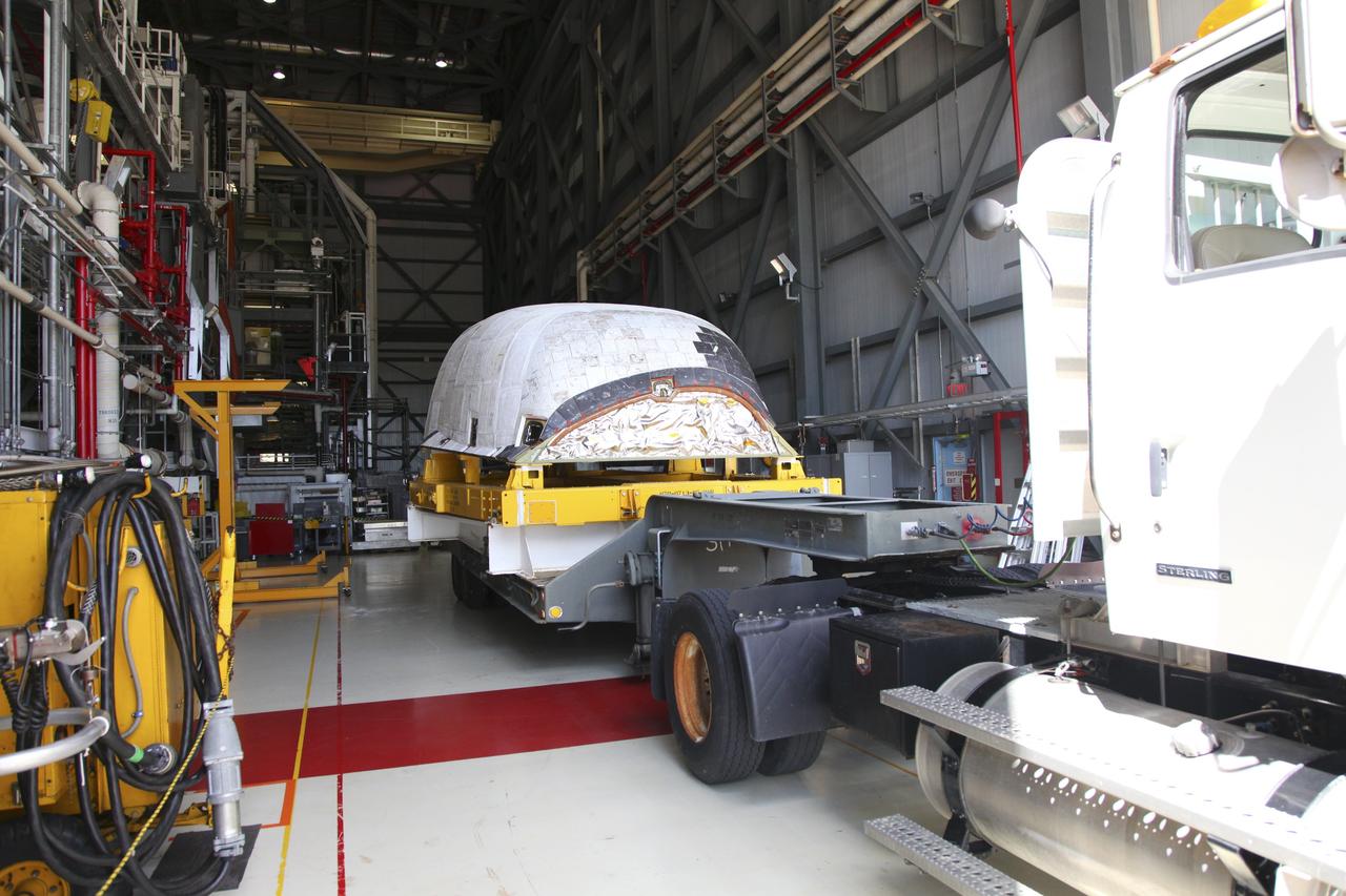 CAPE CANAVERAL, Fla. – At NASA’s Kennedy Space Center in Florida, a truck backs space shuttle Discovery's orbital maneuvering system (OMS) pod into Orbiter Processing Facility-1 (OPF). The OMS has been returned from White Sands Space Harbor in New Mexico where it underwent a complete deservicing and cleaning.          The work is part of the Space Shuttle Program’s transition and retirement processing of space shuttle Discovery. The shuttle will go to the Smithsonian's National Air and Space Museum, Steven F. Udvar-Hazy Center in Chantilly, Va. For more information, visit http://www.nasa.gov/shuttle. Photo credit: NASA/Frankie Martin
