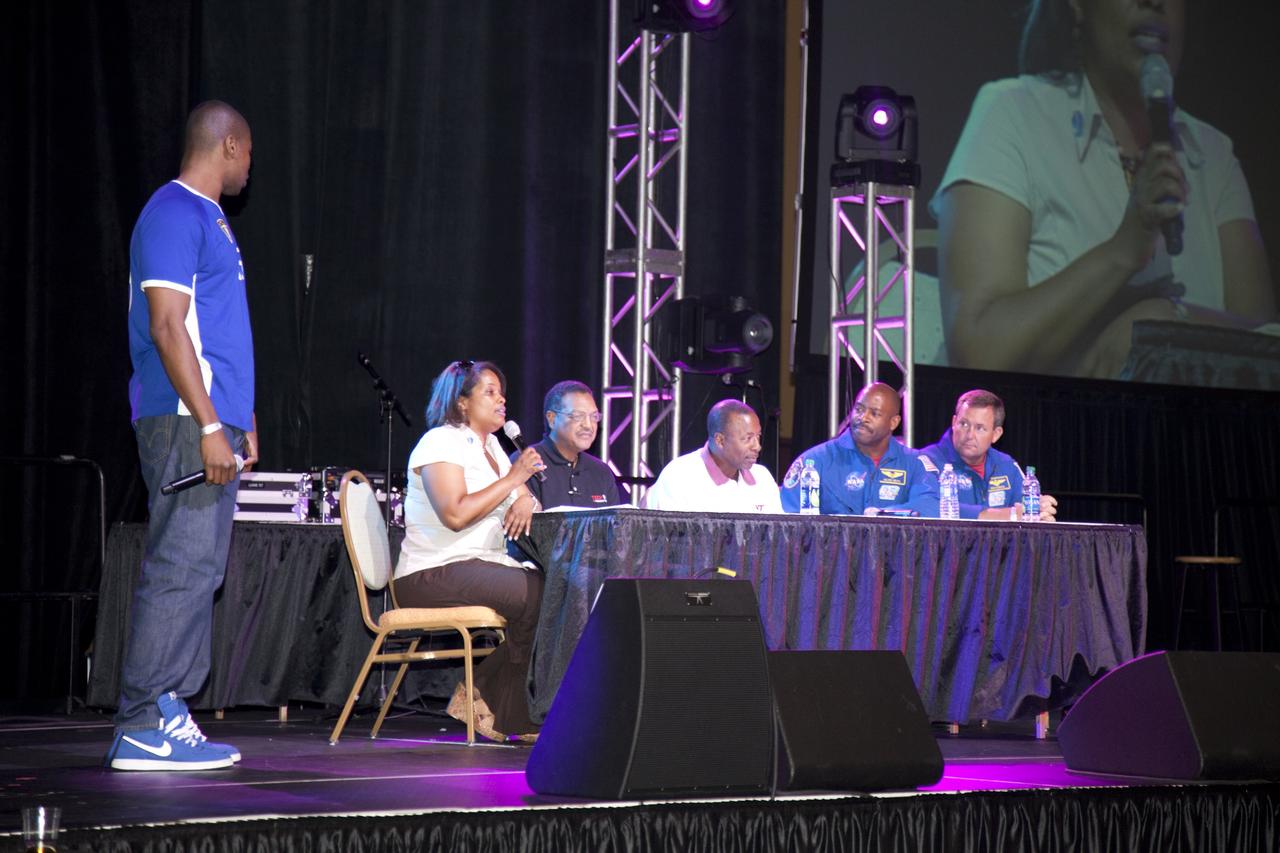 CAPE CANAVERAL, Fla. -- The NASA Legends and Trailblazers Panel take to the stage at the Tom Joyner Family Reunion. From left is the master of ceremonies, Lance Foster (standing) with panel members Robyn Gordon, director of Center Operations, Glenn Research Center; Lewis Braxton, deputy director, Ames Research Center; Woodrow Whitlow, associate administrator for Mission Support Directorates; astronaut Leland Melvin, associate administrator for Education; and astronaut Mike Foreman, Johnson Space Center. The event was held in the Exhibit Hall of the Gaylord Palms Resort and Convention Center in Kissimmee, Fla., and hosted by nationally syndicated radio personality Tom Joyner during the extended Labor Day weekend Sept. 1-4. Besides offering attendees the opportunity to visit tourist attractions in the Orlando area, the reunion gave NASA education specialists an avenue to tout the benefits of math and scientific learning, as well as the many educational opportunities offered by the space agency. For more information on NASA's education initiatives, visit http://www.nasa.gov/education. Photo credit: NASA/Frankie Martin